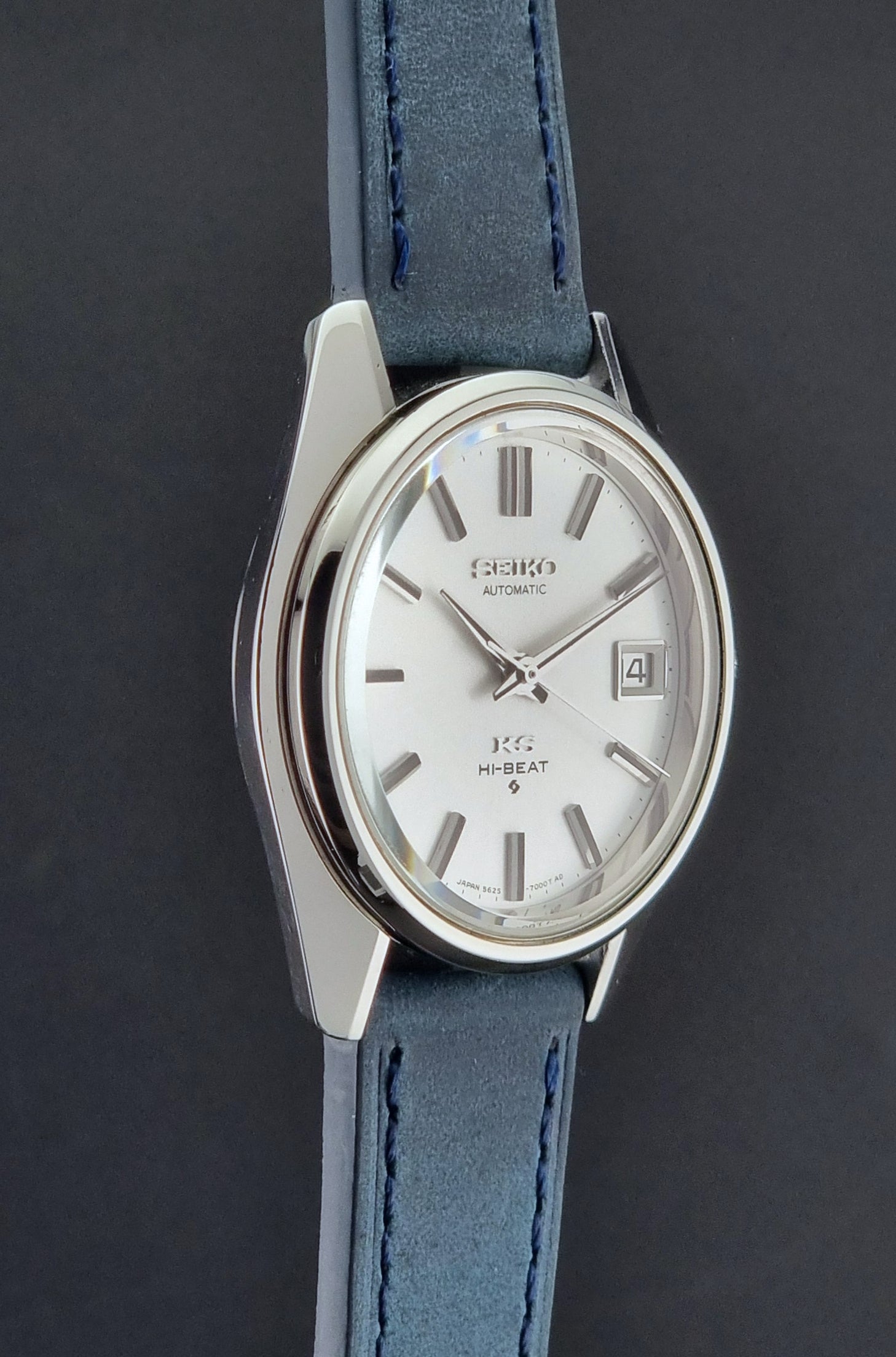 Vintage King Seiko 5625-7000 Wristwatch with blue strap and silver case on a dark textured background