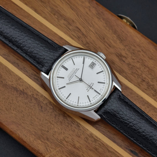 Vintage King Seiko 5625-7041 Wristwatch with black leather strap on a wooden surface