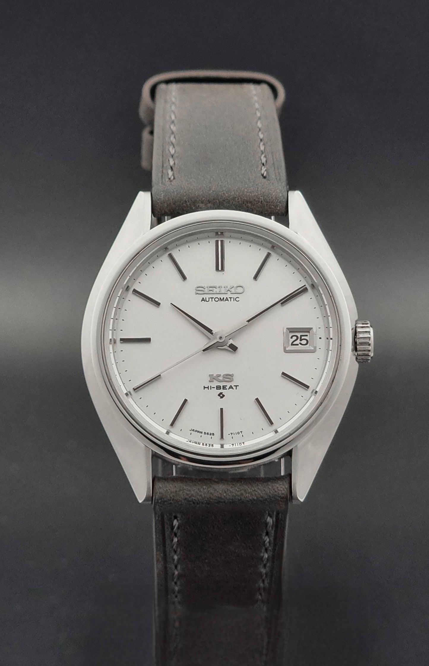 Vintage King Seiko 5625-7110 Wristwatch with a gray strap and white dial on a brown background close dial view