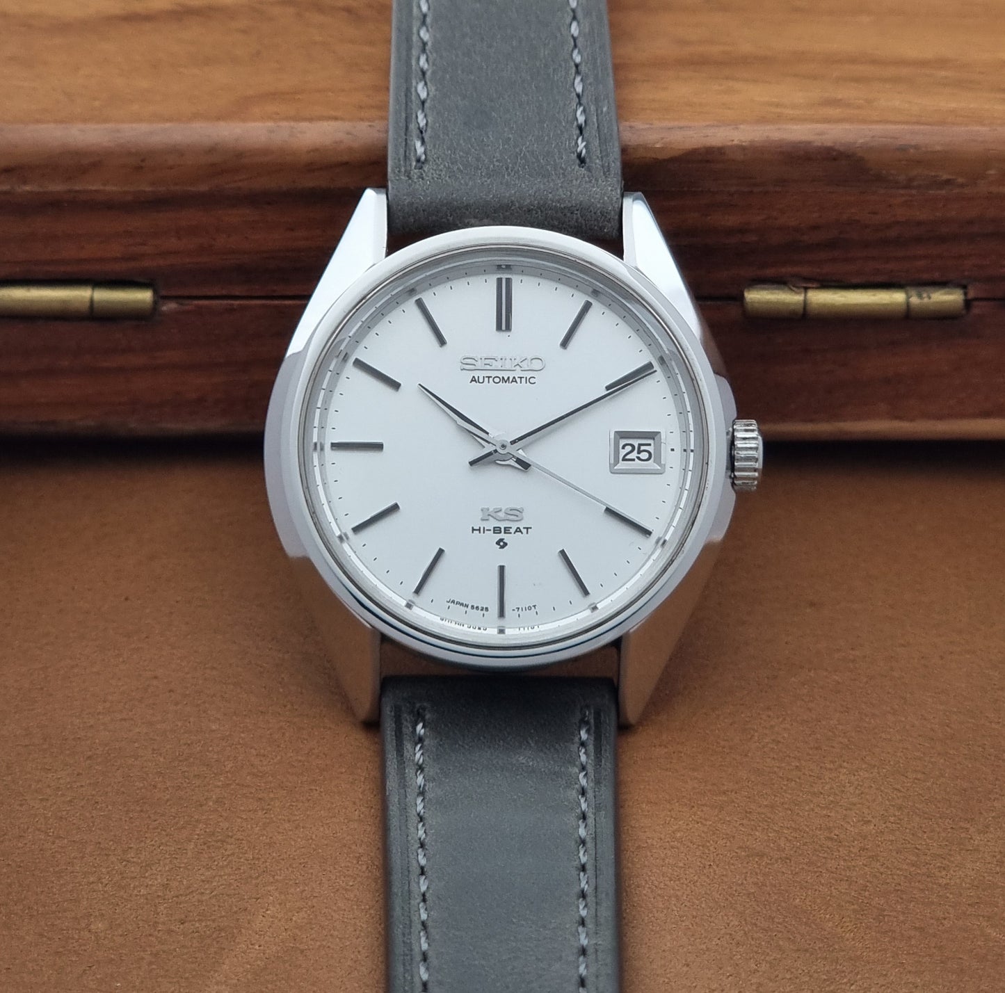 Vintage King Seiko 5625-7110 Wristwatch with a gray strap and white dial on a brown background dial view