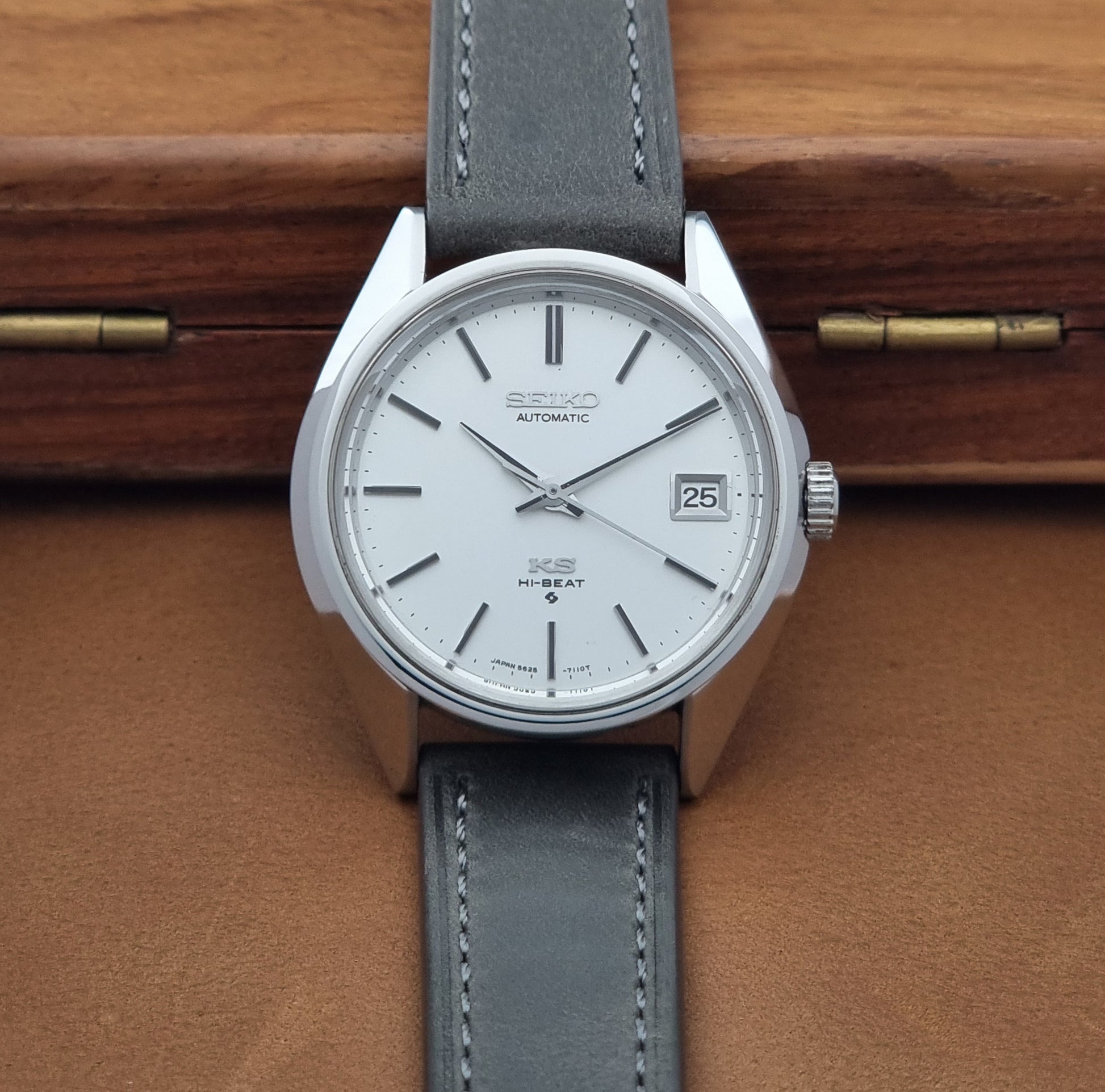 Vintage King Seiko 5625-7110 Wristwatch with a gray strap and white dial on a brown background dial view