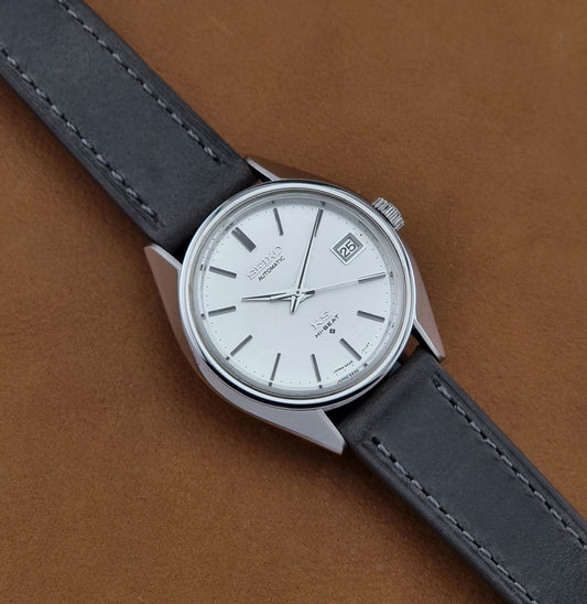 Vintage King Seiko 5625-7110 Wristwatch with a gray strap and white dial on a brown background dial