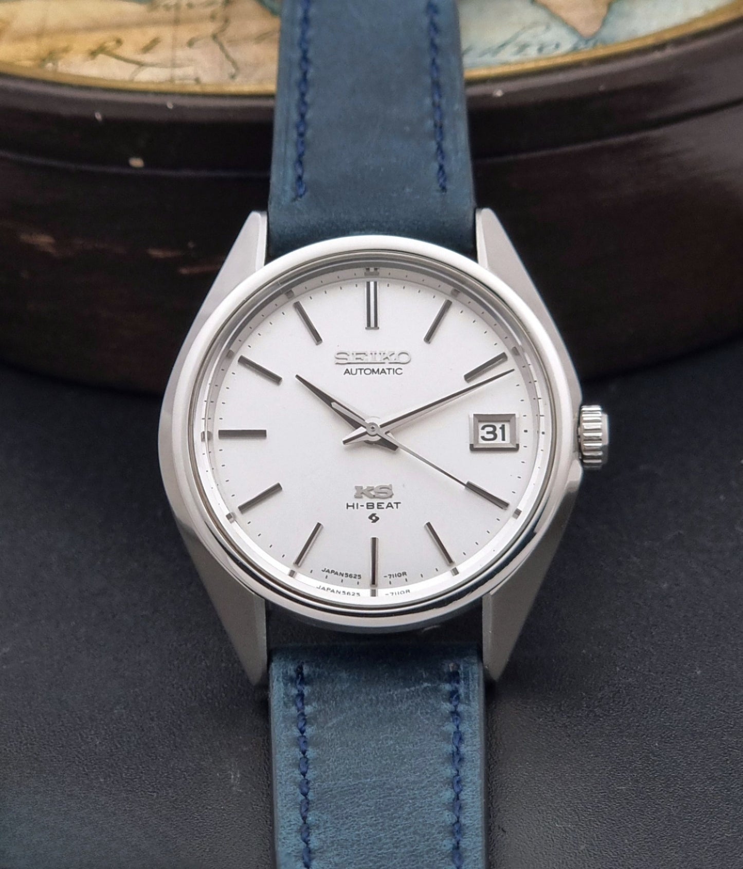 Vintage King Seiko Wristwatch 5625-7110 blue strap and silver case on a dark surface dial view