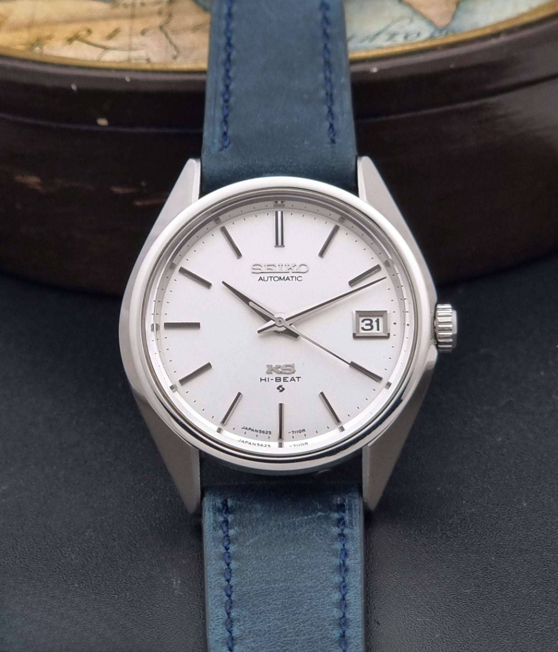 Vintage King Seiko Wristwatch 5625-7110 blue strap and silver case on a dark surface dial view
