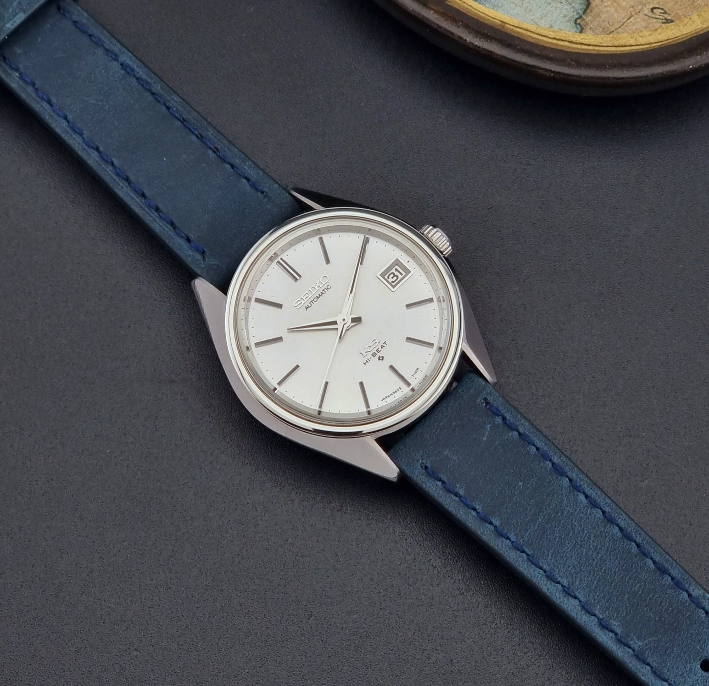 Vintage King Seiko Wristwatch 5625-7110 blue strap and silver case on a dark surface dial