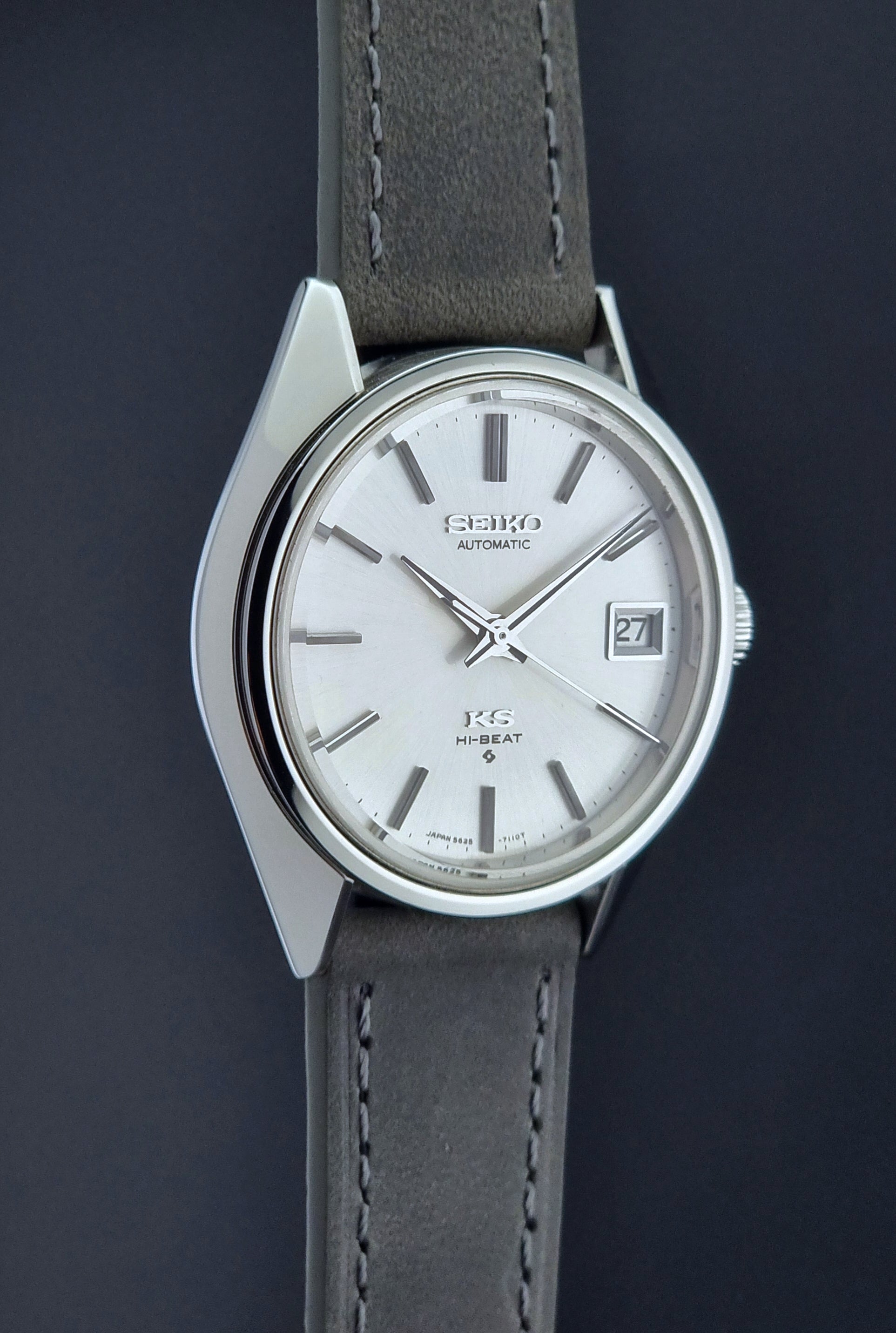 Vintage King Seiko watch with gray strap on a dark background