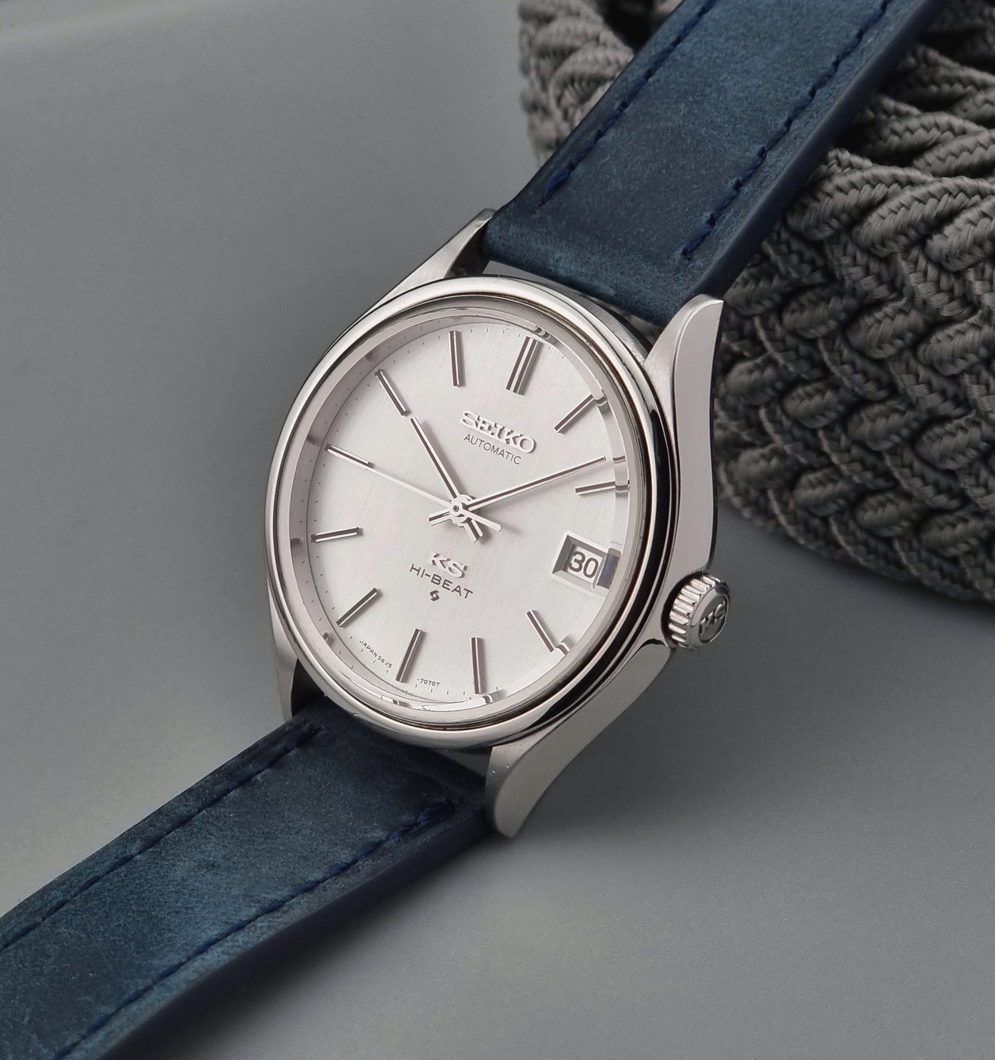 Vintage King Seiko watch with a blue strap on a gray background