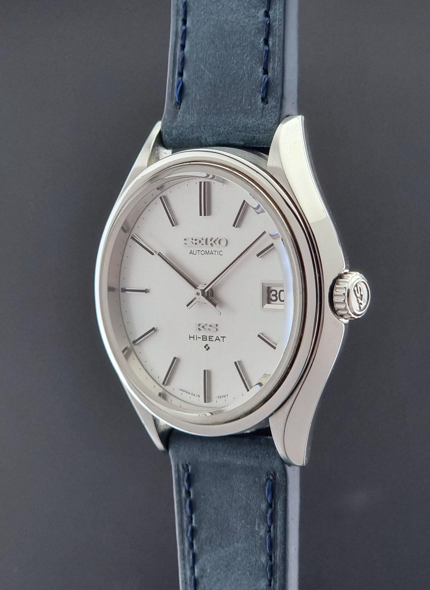 Vintage King Seiko watch with blue strap on a dark background