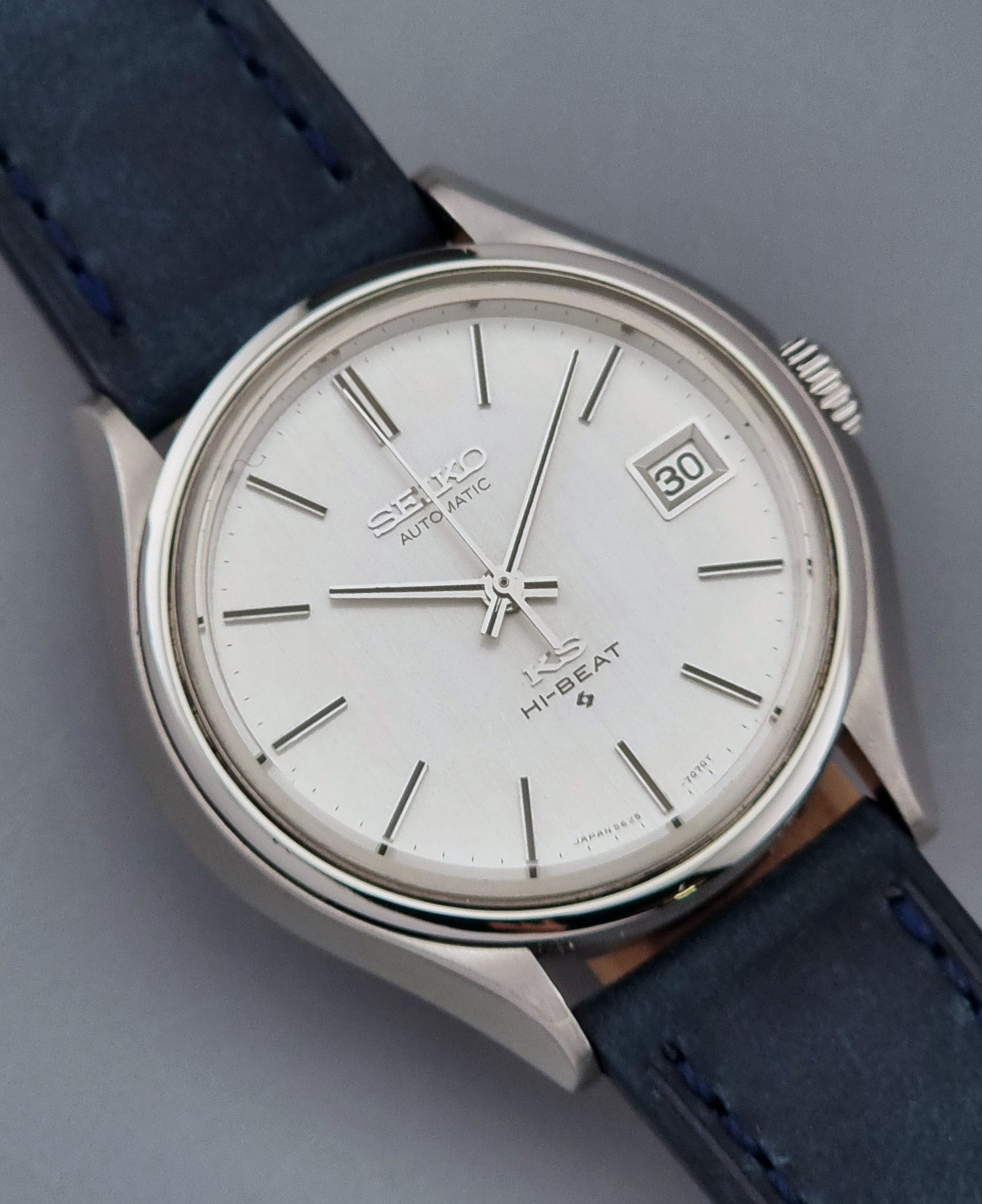 Vintage King Seiko watch with a blue strap on a gray background