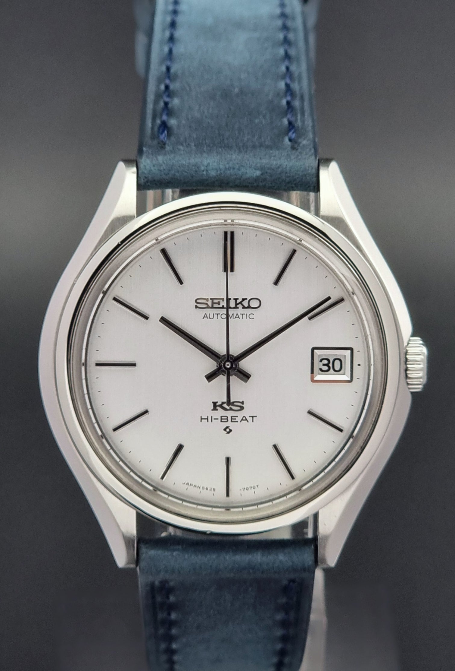 Vintage King Seiko watch with blue strap on a dark background