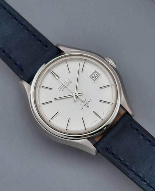 Vintage King Seiko watch with blue leather strap on a gray background