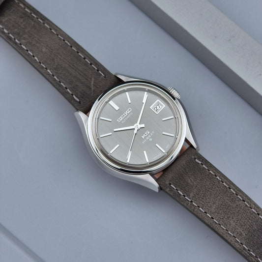 Vintage King Seiko watch 5625-7120 with a grey leather strap on a grey background
