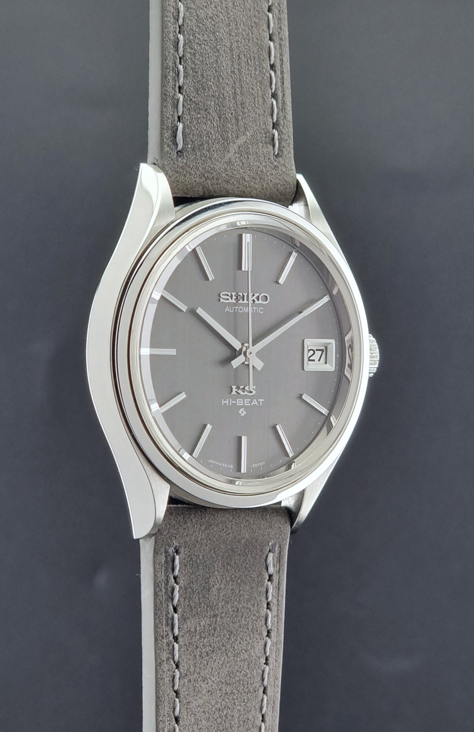 Vintage King Seiko watch 5625-7120 with a grey leather strap on a grey background side profile view