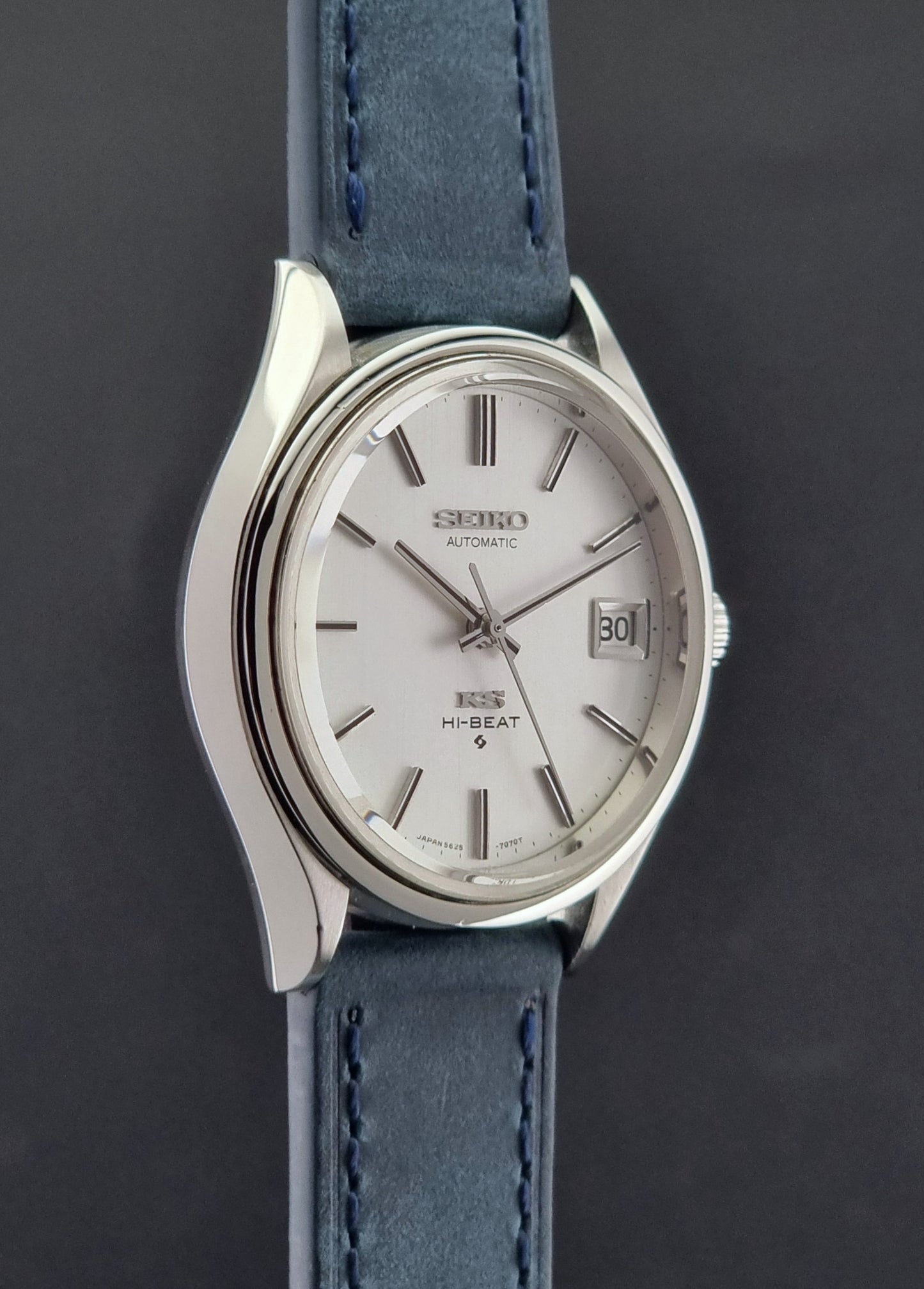 Vintage King Seiko watch with silver dial and blue leather strap on a dark background
