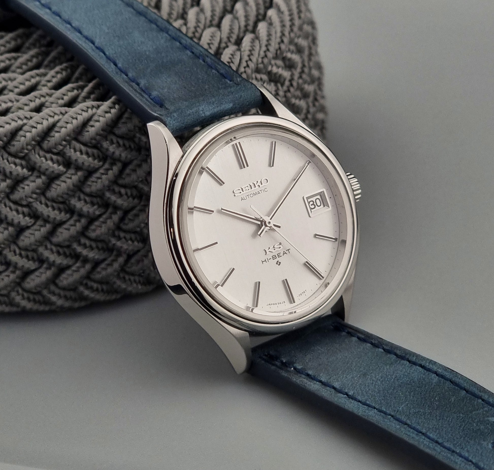 Vintage King Seiko watch with blue strap on a gray background