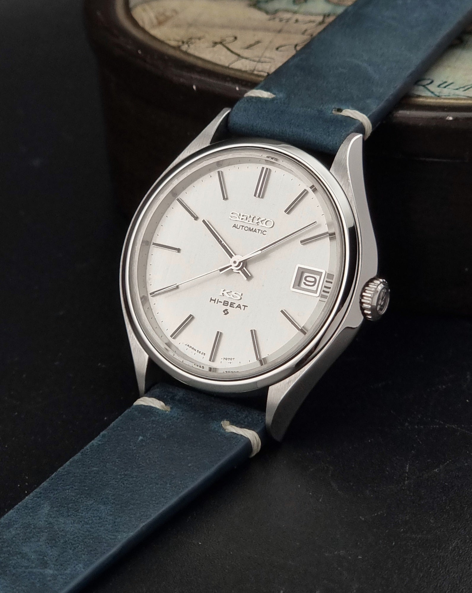 Vintage King Seiko 5625-7121 watch with blue strap on a dark gray background crown view