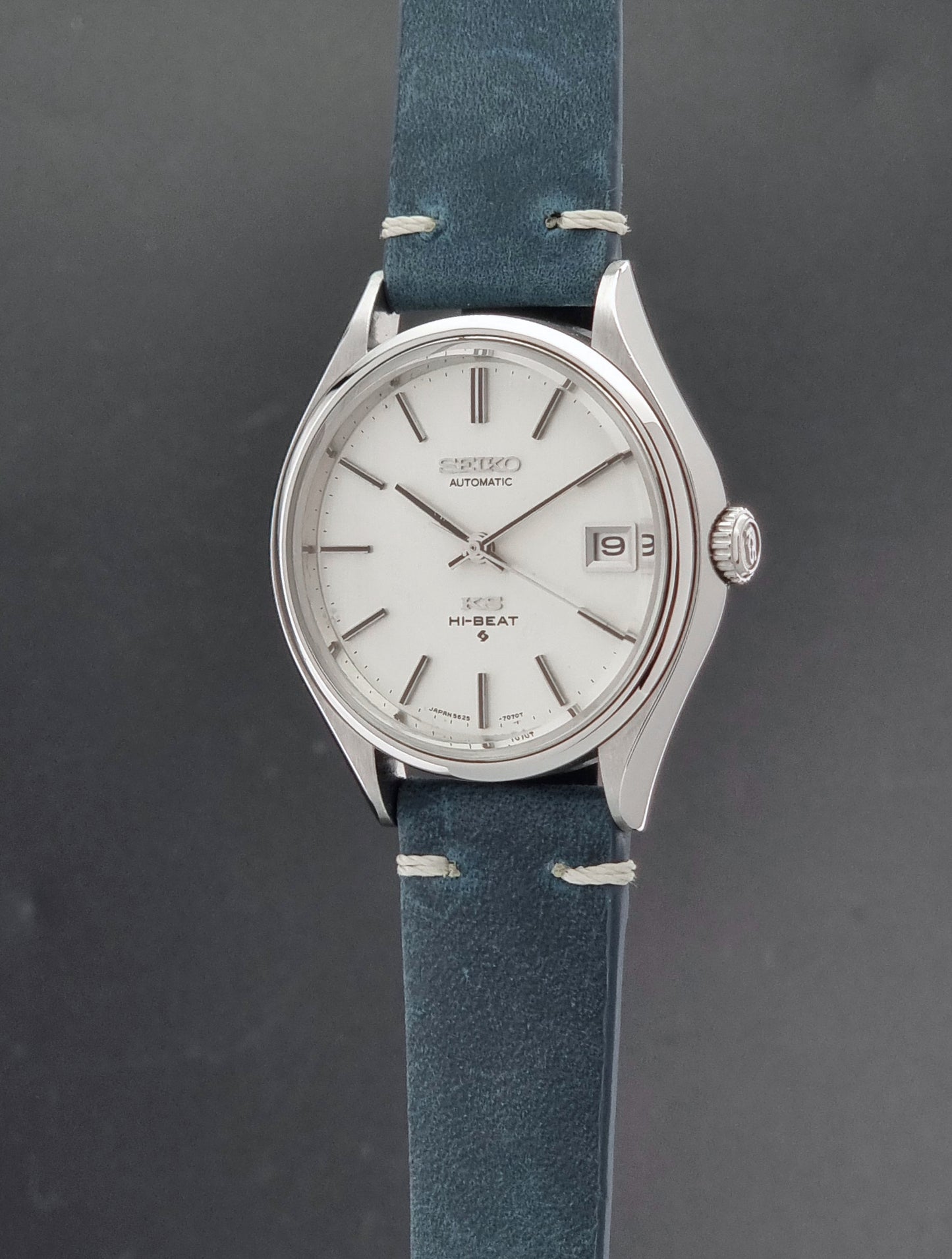 Vintage King Seiko 5625-7121 watch with blue strap on a dark gray background crown profile view