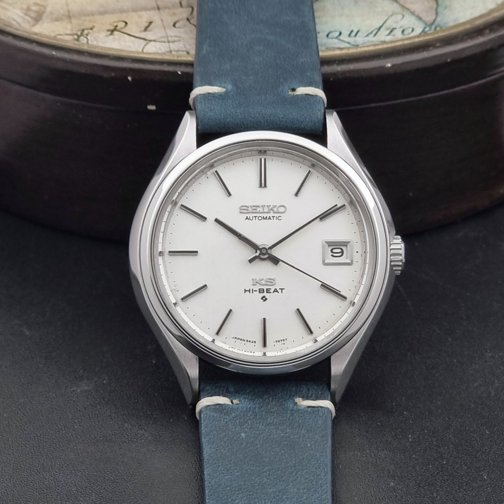 Vintage King Seiko 5625-7121 watch with blue strap on a dark gray background dial view