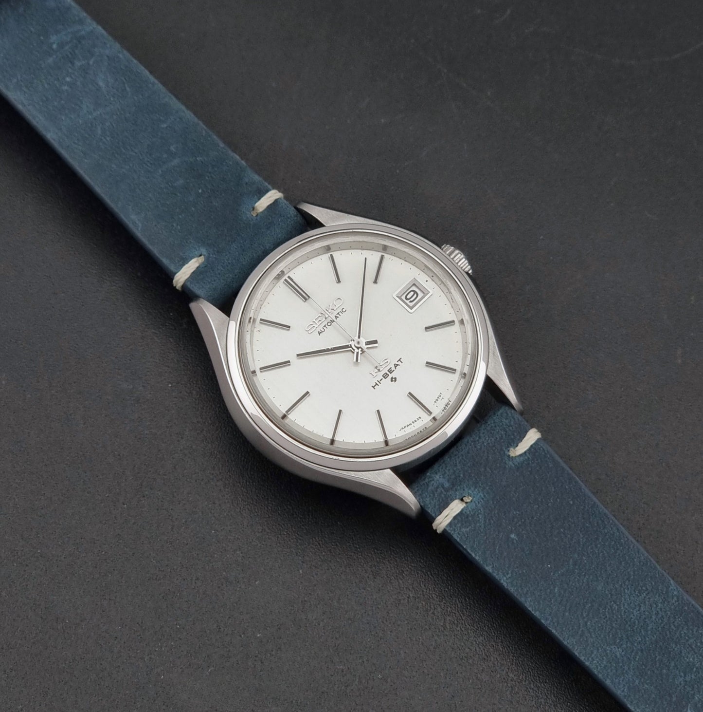 Vintage King Seiko 5625-7121 watch with blue strap on a dark gray background dial