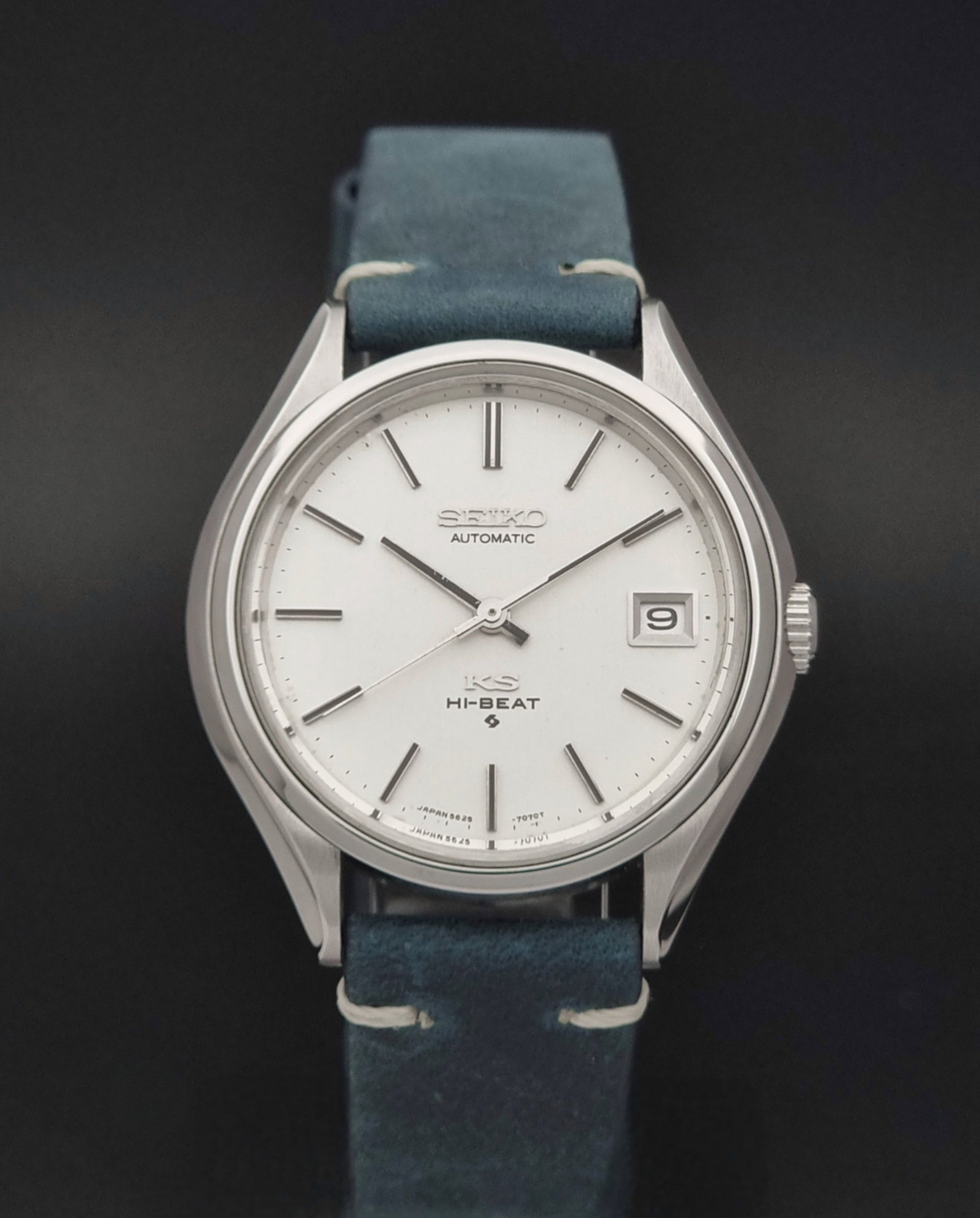 Vintage King Seiko 5625-7121 watch with blue strap on a dark gray background close dial view