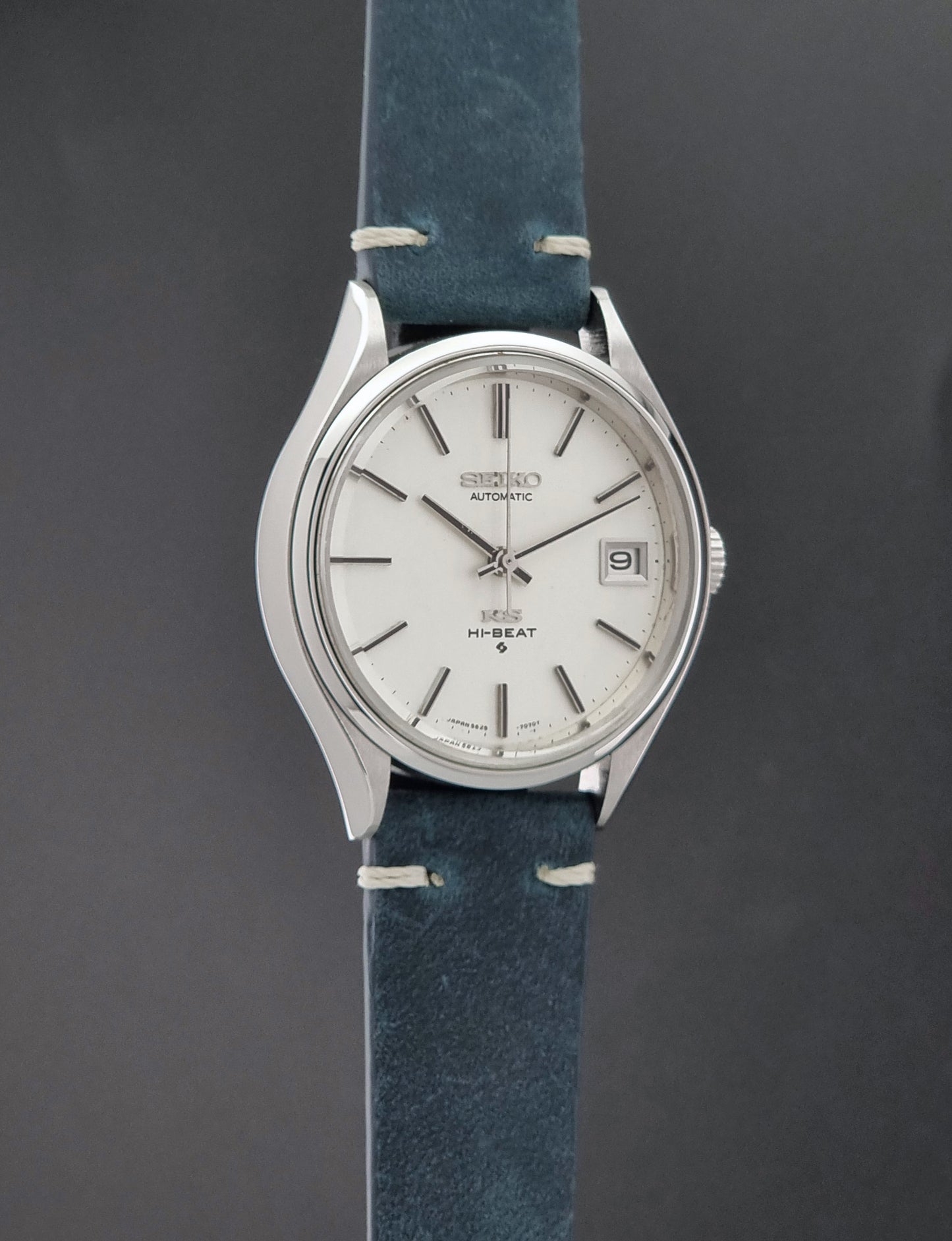 Vintage King Seiko 5625-7121 watch with blue strap on a dark gray background side profile view