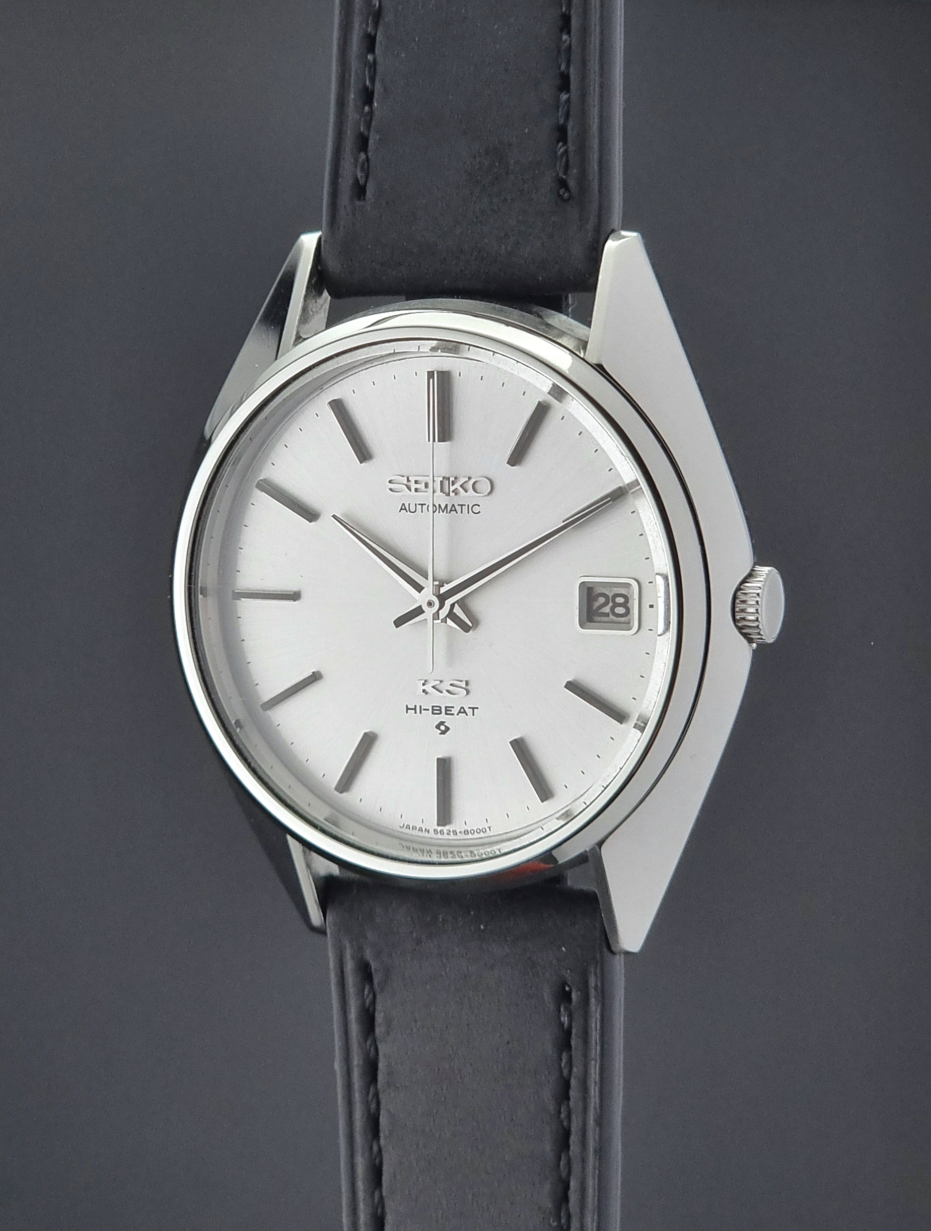 Vintage King Seiko watch with black leather strap on a dark background