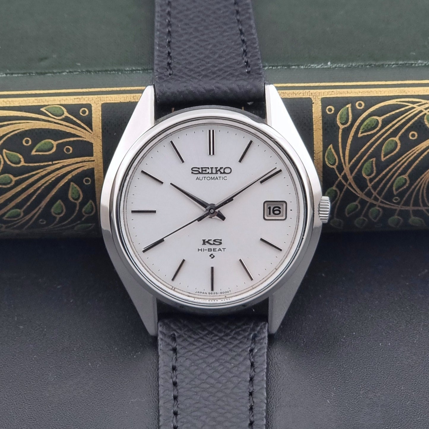 Vintage King Seiko Wristwatch 5625-8000 with a black leather strap on a dark background dial view