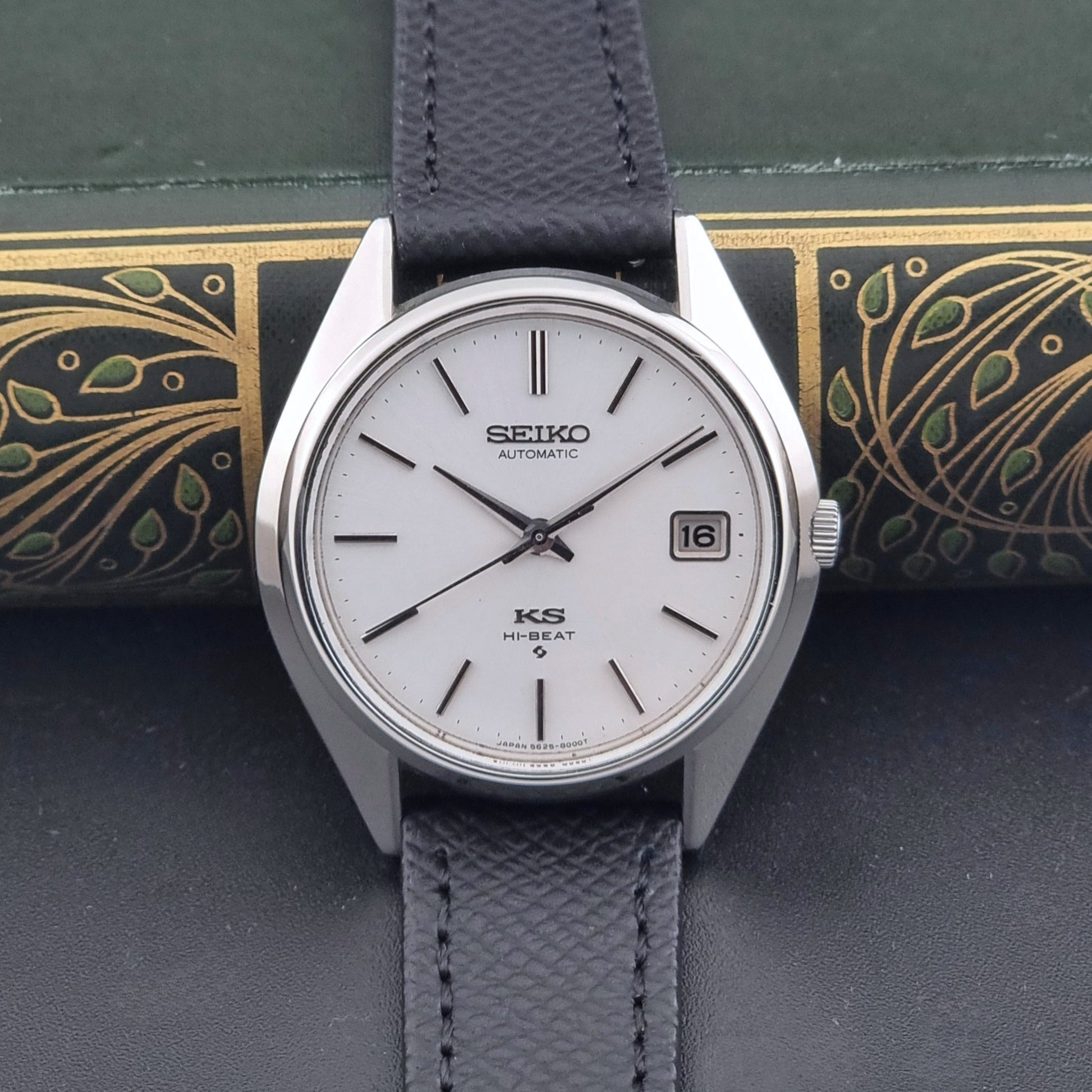 Vintage King Seiko Wristwatch 5625-8000 with a black leather strap on a dark background dial view