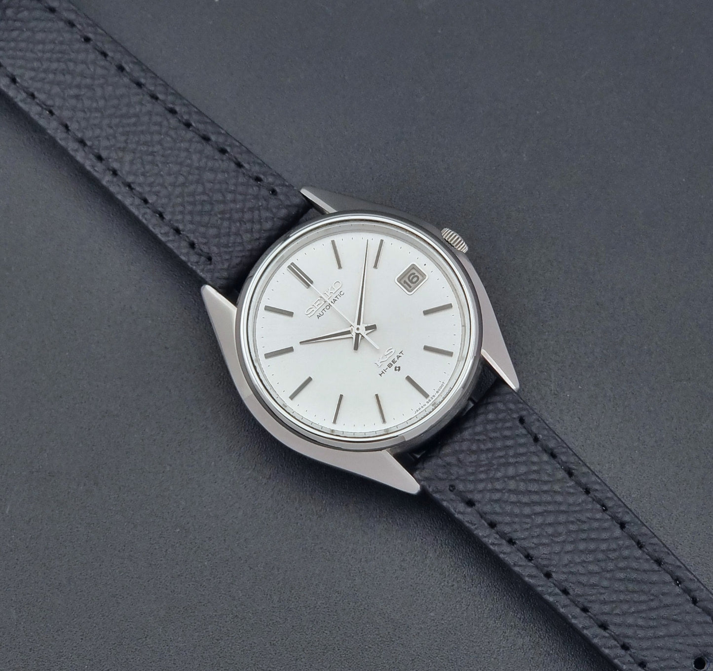 Vintage King Seiko Wristwatch 5625-8000 with a black leather strap on a dark background dial