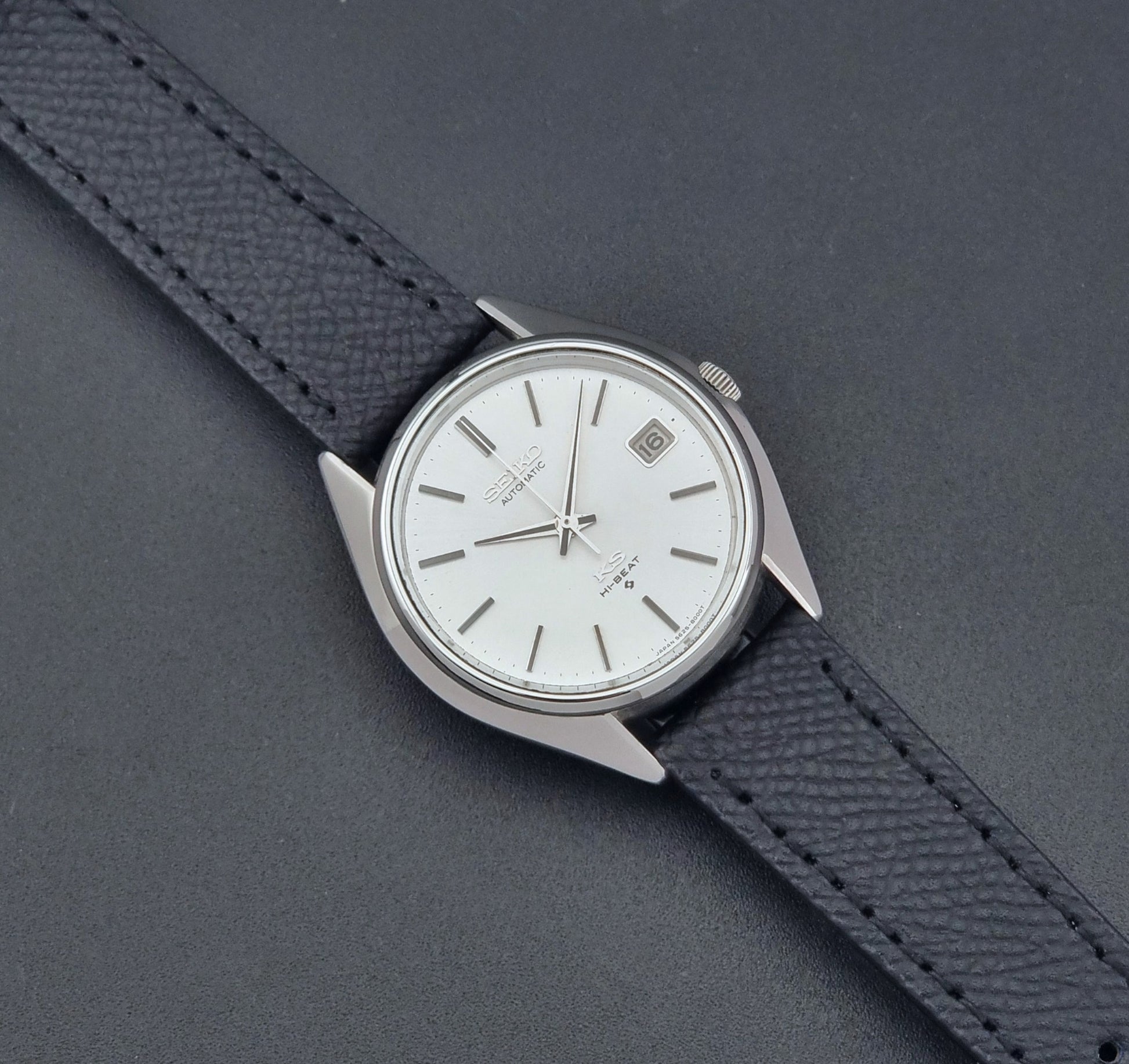Vintage King Seiko Wristwatch 5625-8000 with a black leather strap on a dark background dial