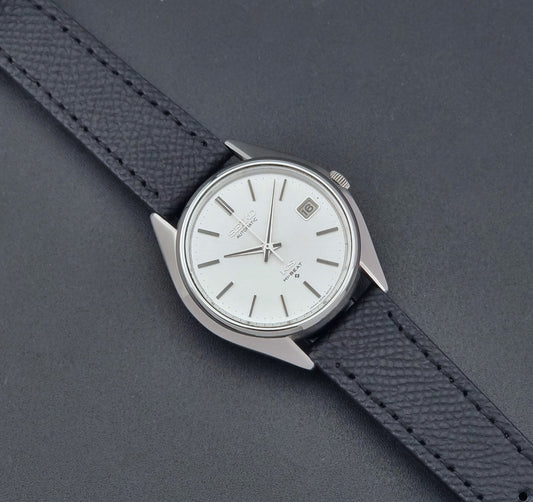 Vintage King Seiko Wristwatch 5625-8000 with a black leather strap on a dark background dial