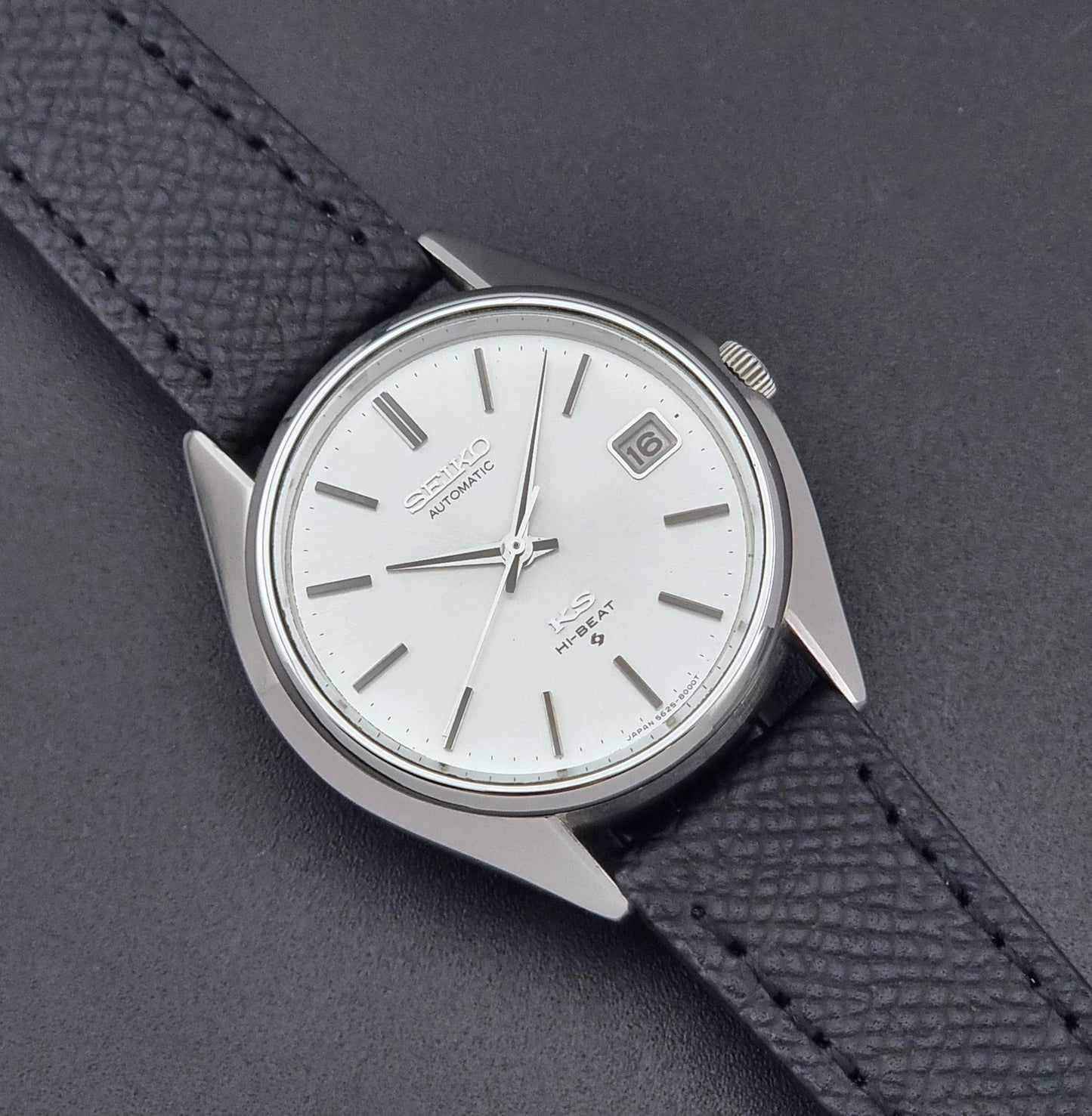 Vintage King Seiko Wristwatch 5625-8000 with a black leather strap on a dark background close up dial view