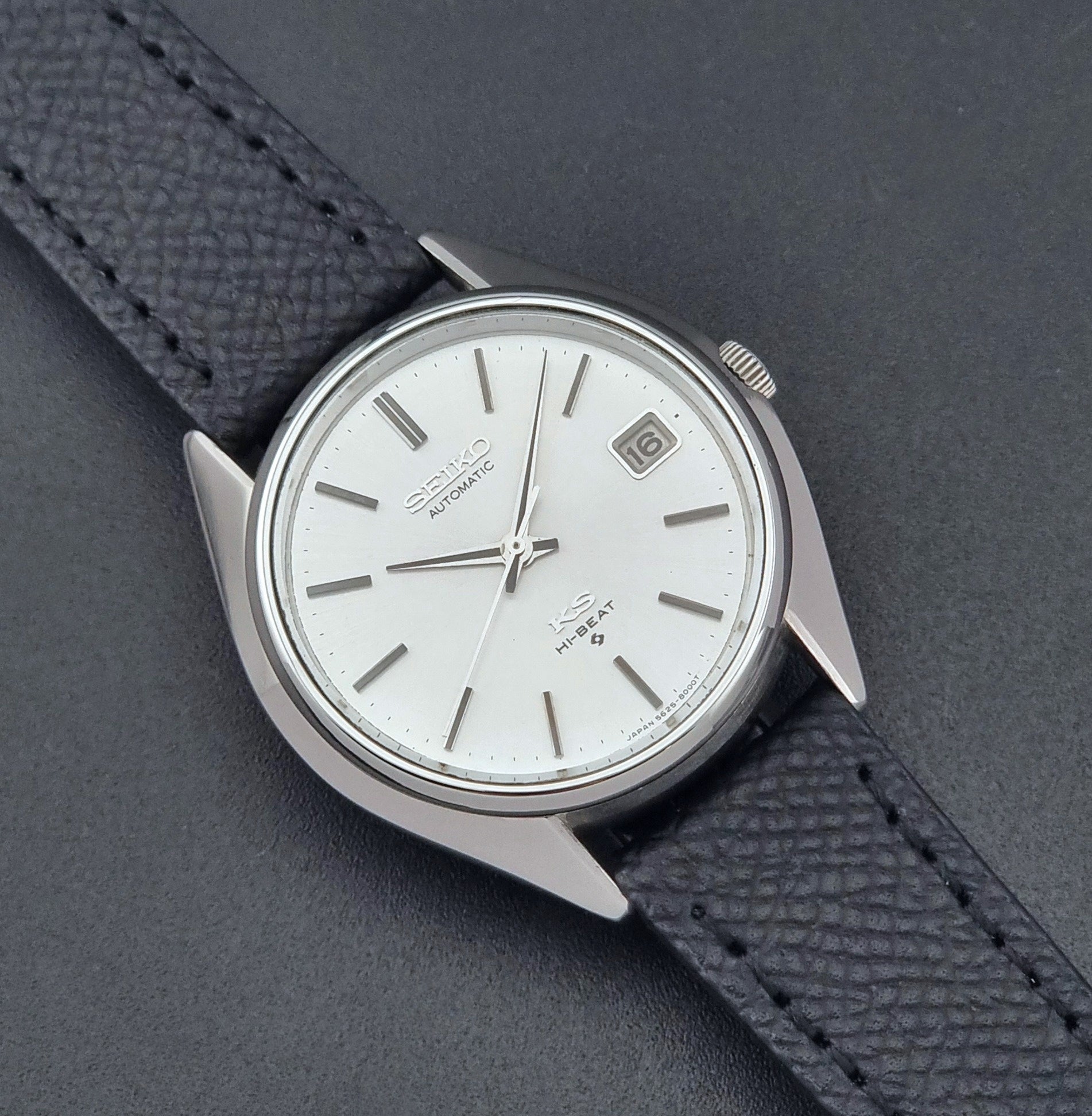 Vintage King Seiko Wristwatch 5625-8000 with a black leather strap on a dark background close up dial view