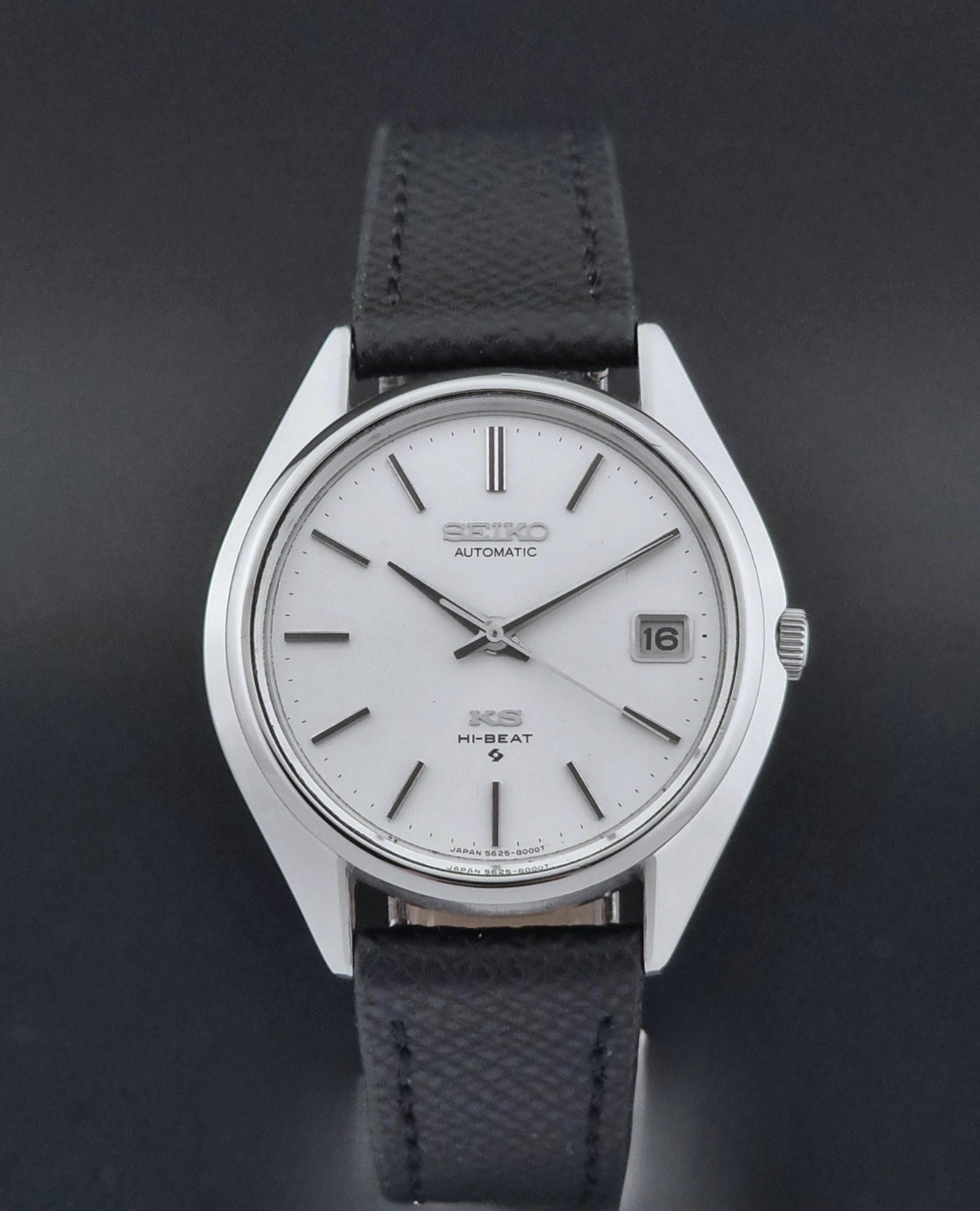 Vintage King Seiko Wristwatch 5625-8000 with a black leather strap on a dark background close dial view