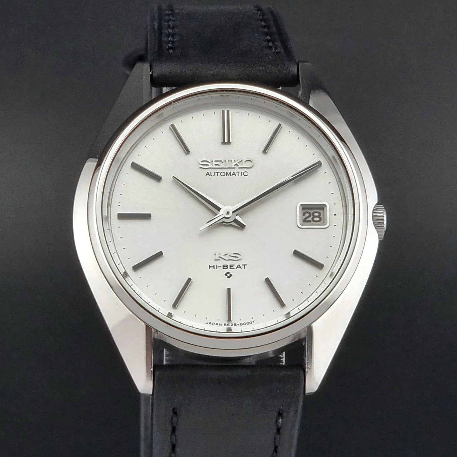 Vintage King Seiko watch with black leather strap on a dark background
