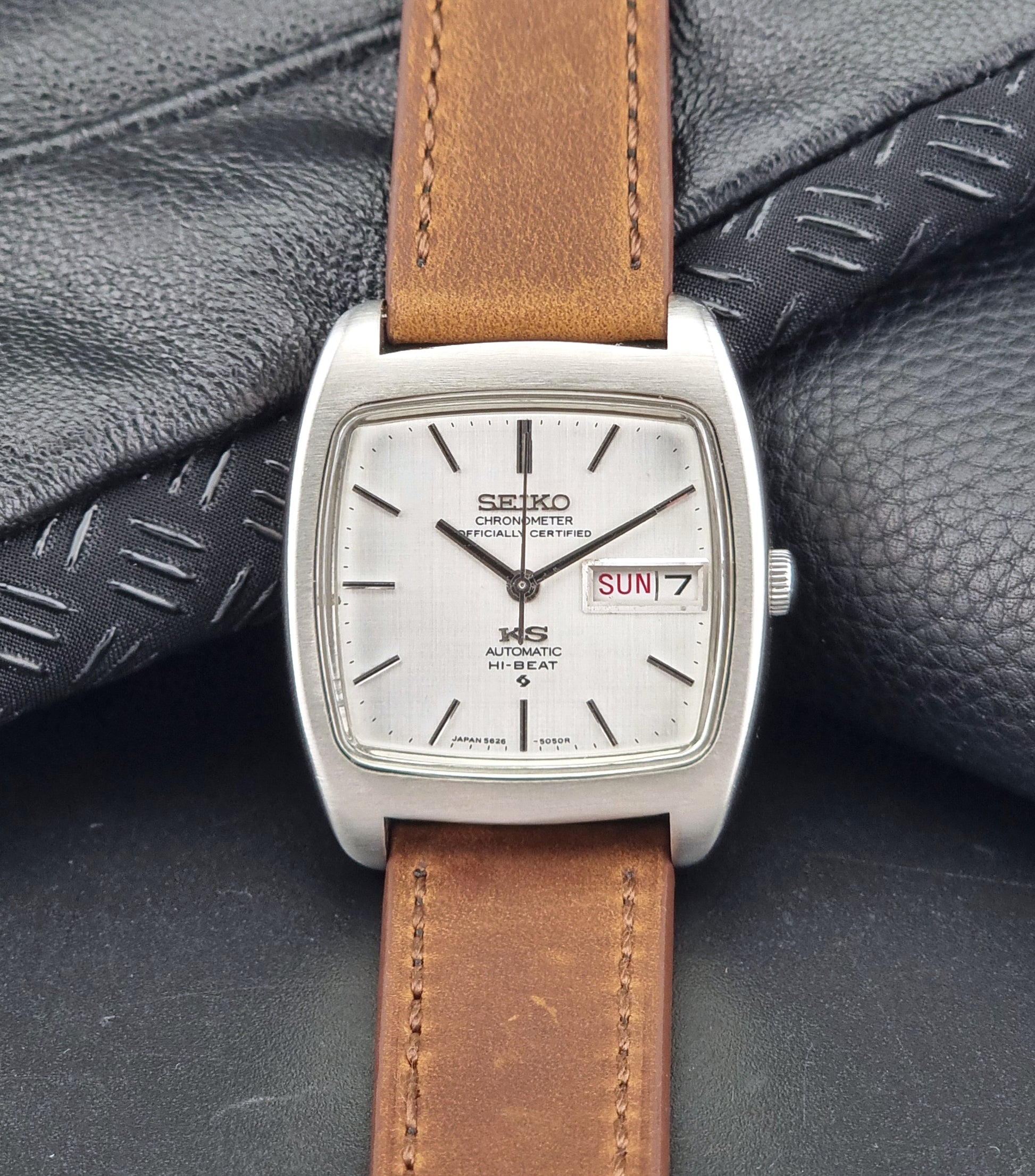 Vintage King Seiko 5626-5040 watch with brown leather strap on a textured gray background