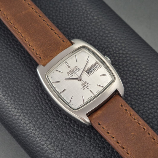 Vintage King Seiko 5626-5040 watch with brown leather strap on a textured gray background