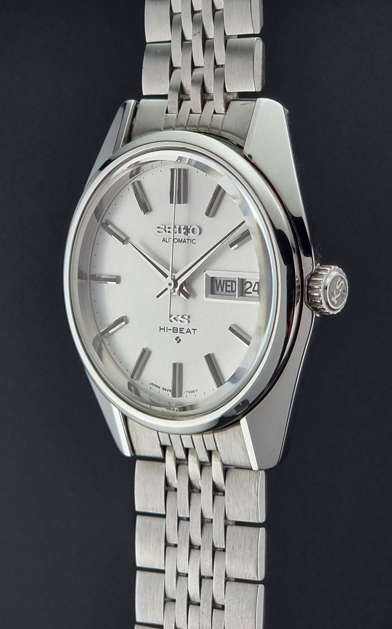 Vintage King Seiko watch with a metal bracelet with a white face on a black background