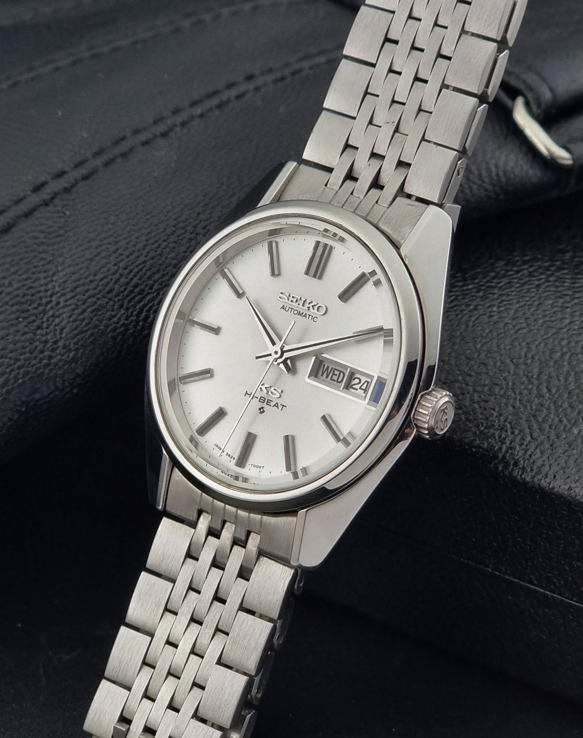 Vintage King Seiko watch with a metal bracelet on a dark textured background