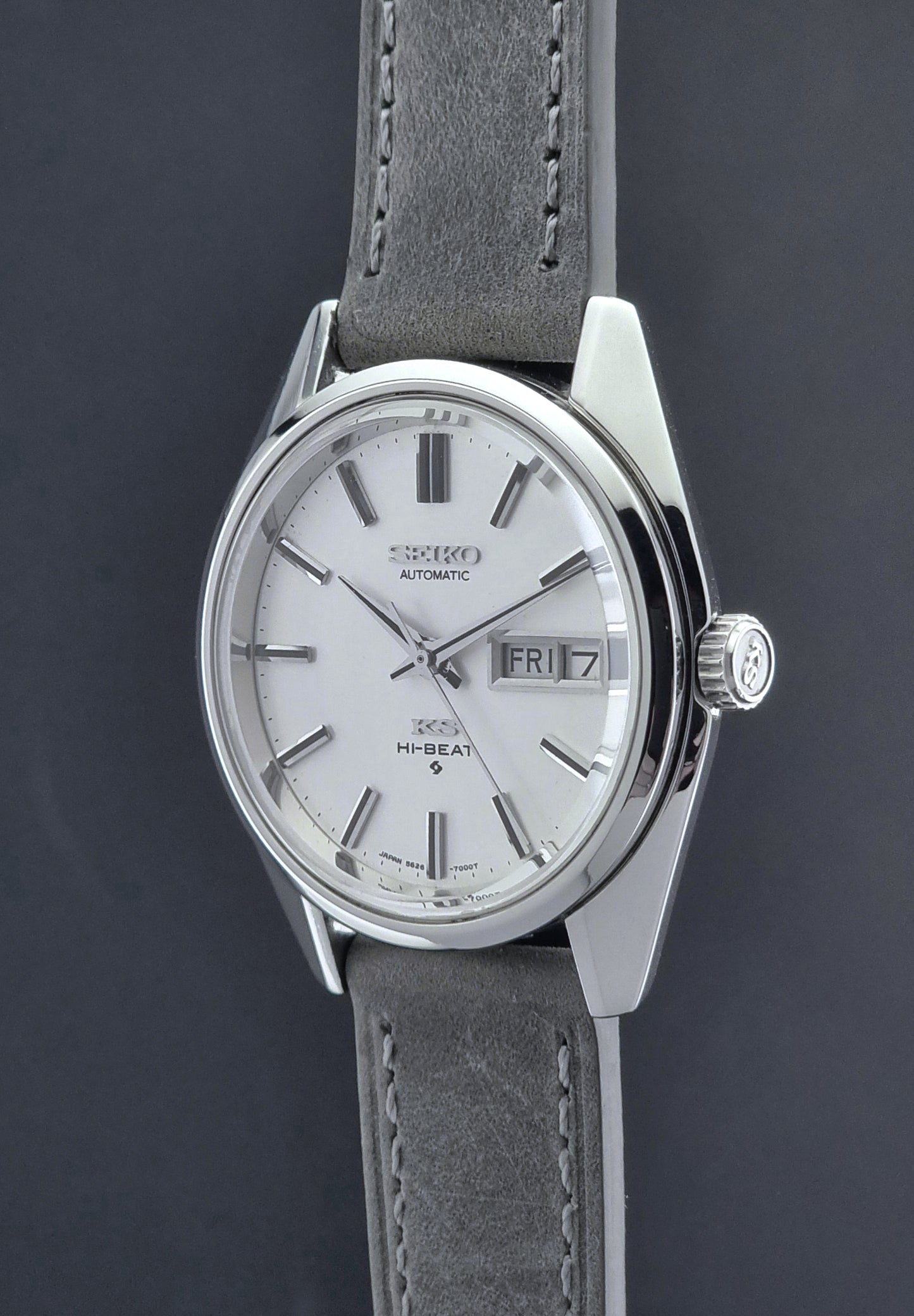 Vintage King Seiko wristwatch with gray leather strap on a dark background crown profile