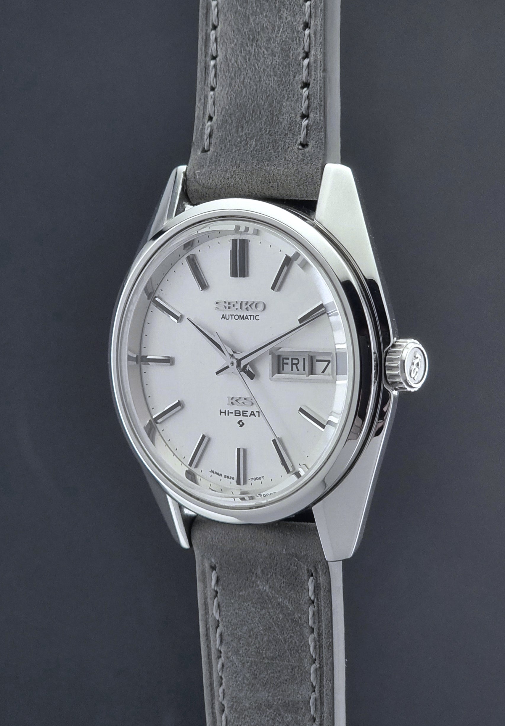 Vintage King Seiko wristwatch with gray leather strap on a dark background crown profile