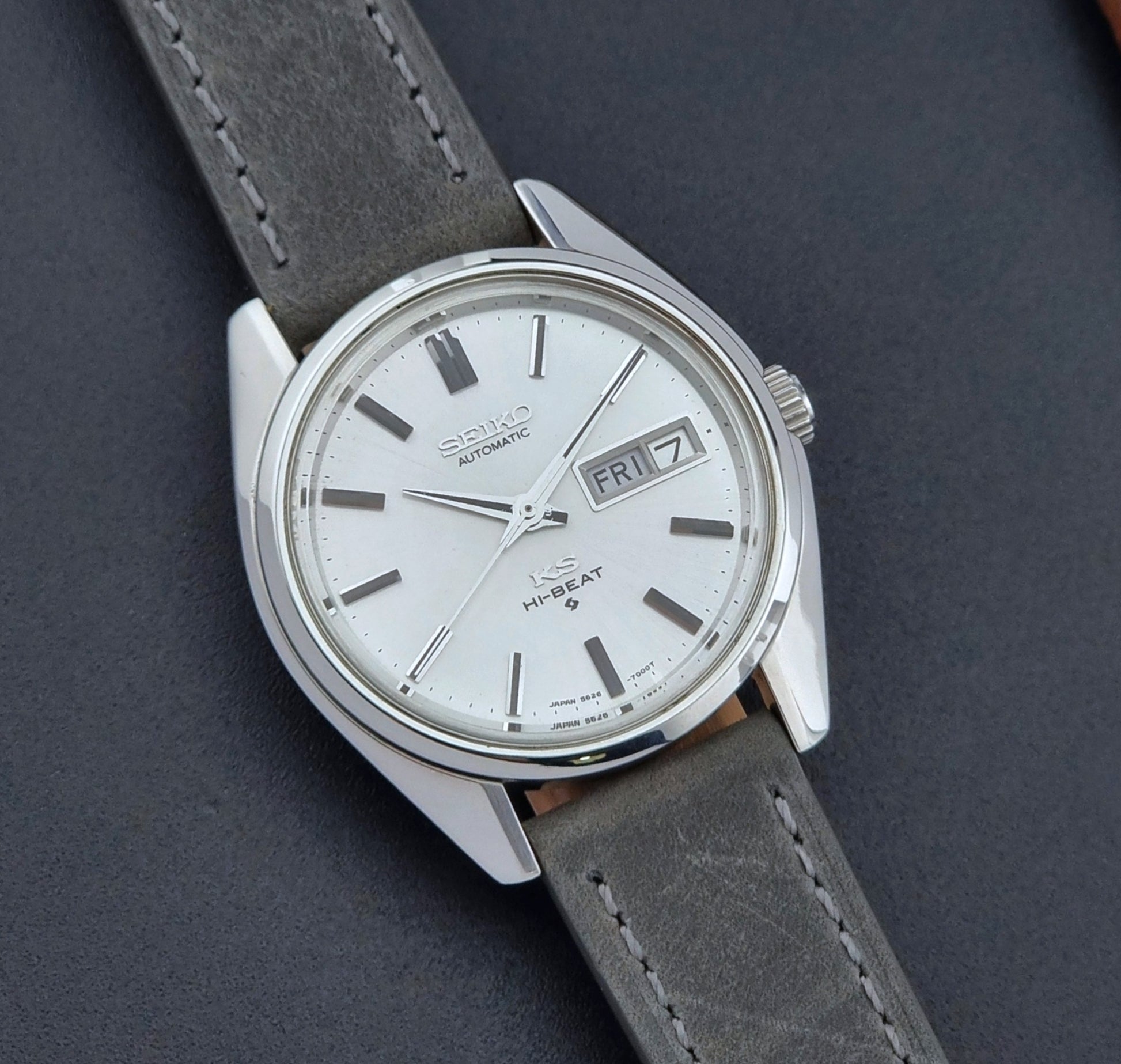 Vintage King Seiko wristwatch with gray leather strap on a dark background close up dial view