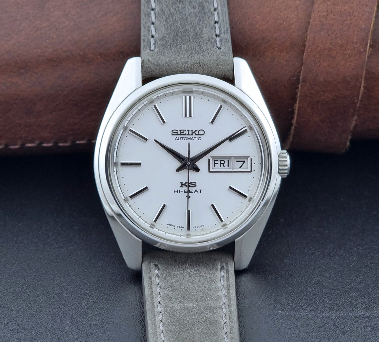 Vintage King Seiko wristwatch with gray leather strap on a dark background close up dial view 