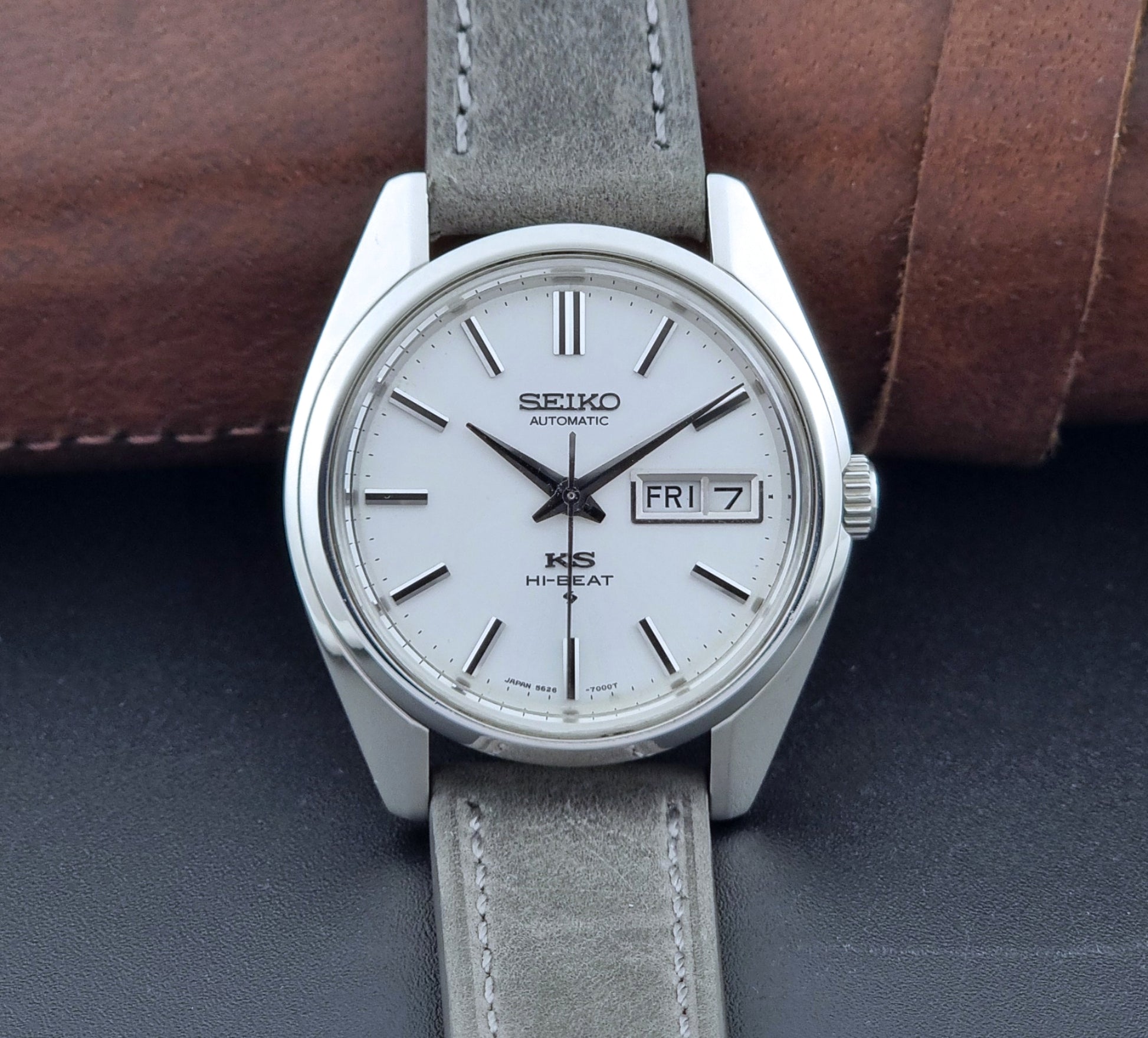 Vintage King Seiko wristwatch with gray leather strap on a dark background close up dial view 