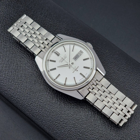 Vintage King Seiko watch with a metal bracelet on a dark textured surface