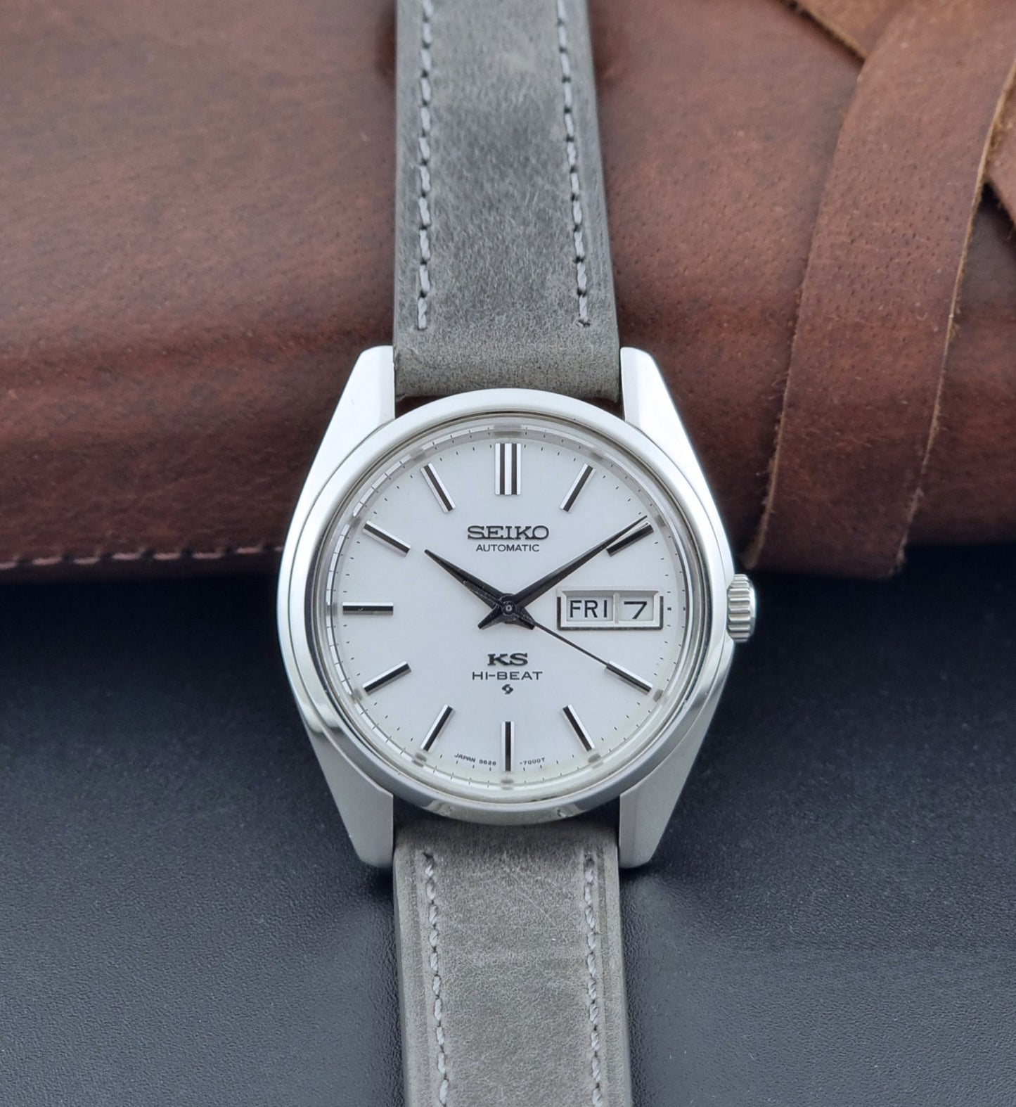 Vintage King Seiko wristwatch with gray leather strap on a dark background dial view