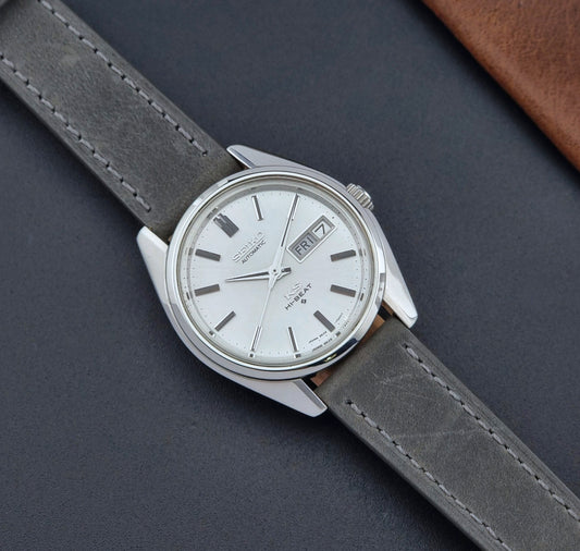 Vintage King Seiko wristwatch with gray leather strap on a dark background dial