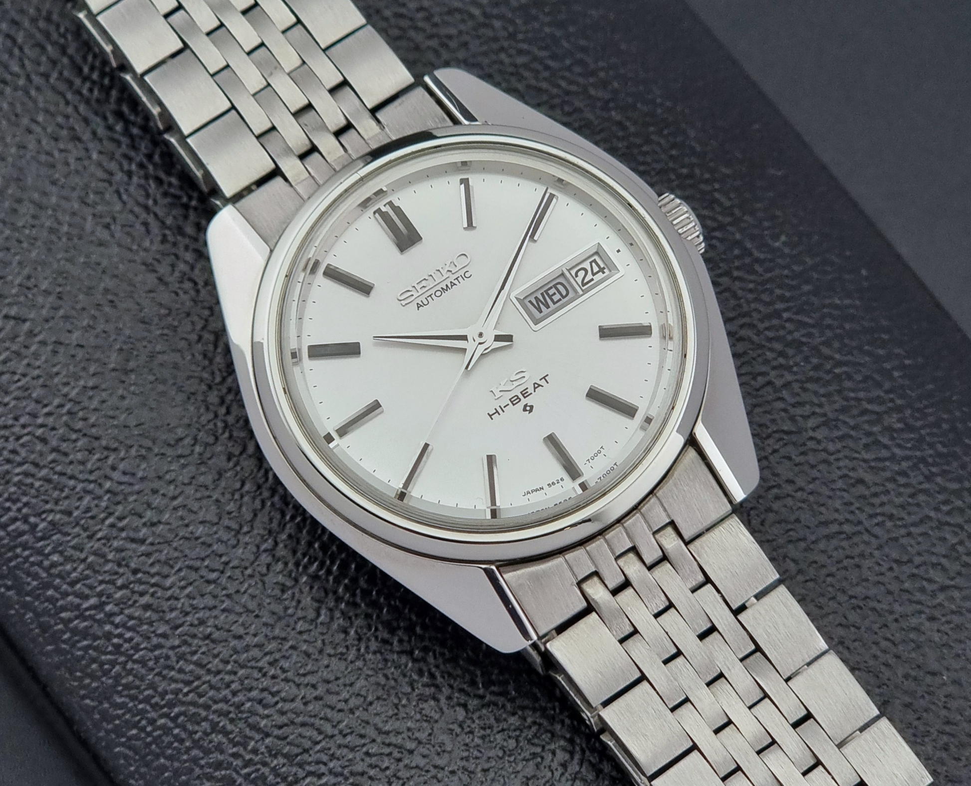 Vintage King Seiko watch with a metal bracelet on a dark textured background