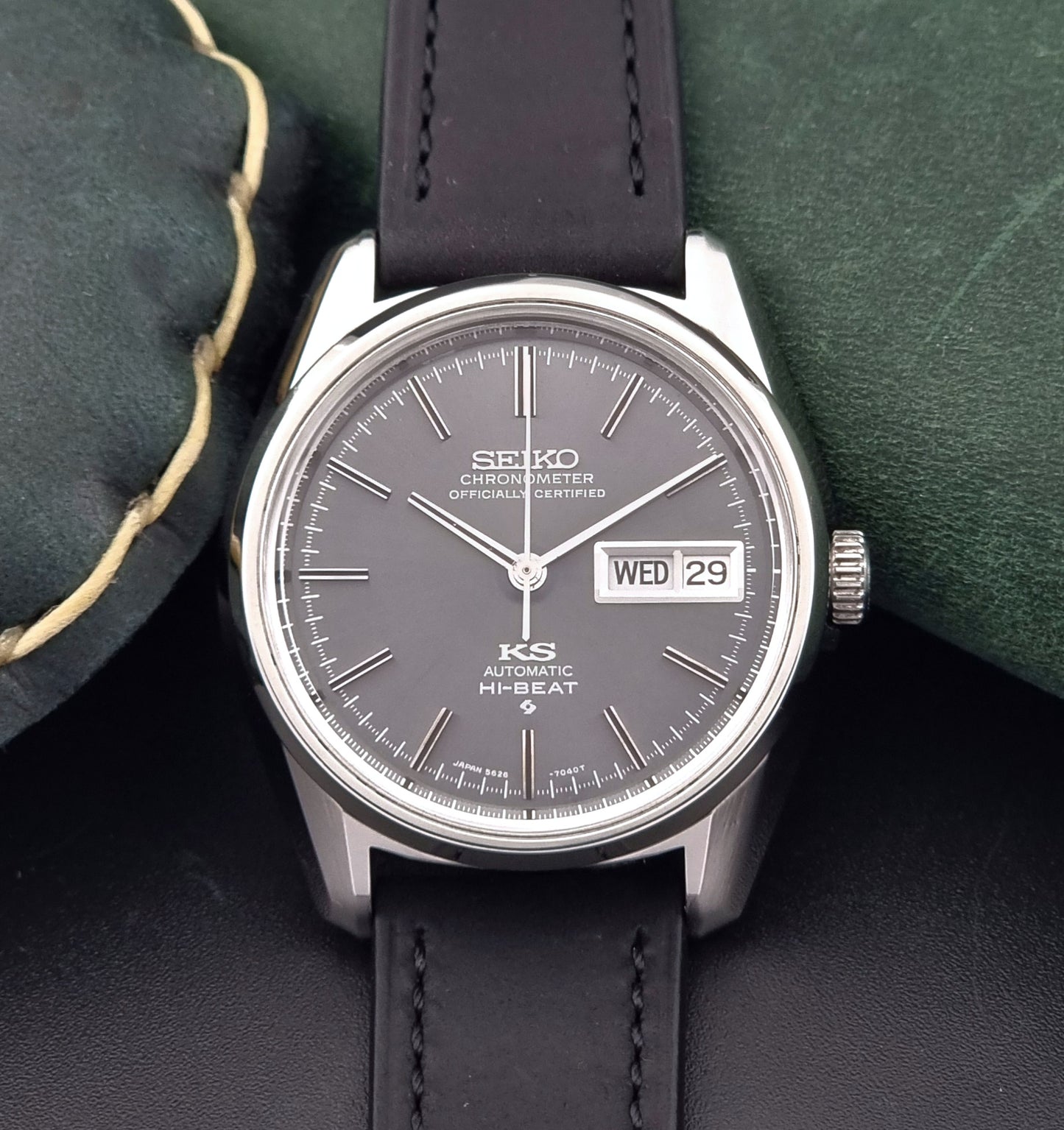 King Seiko watch 5626-7040 watch with black leather strap on a green and gray background close up dial