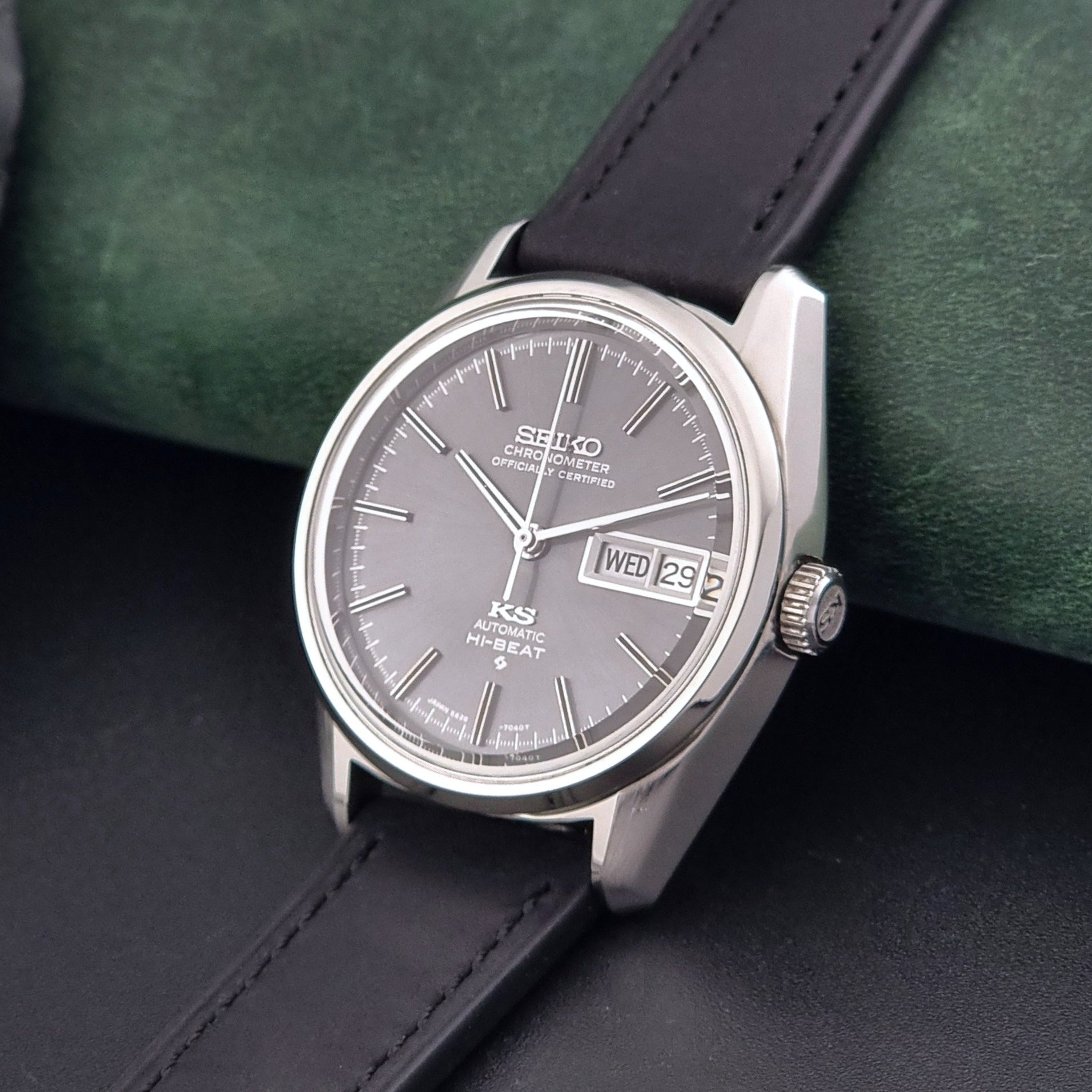 King Seiko watch 5626-7040 watch with black leather strap on a green and gray background crown view